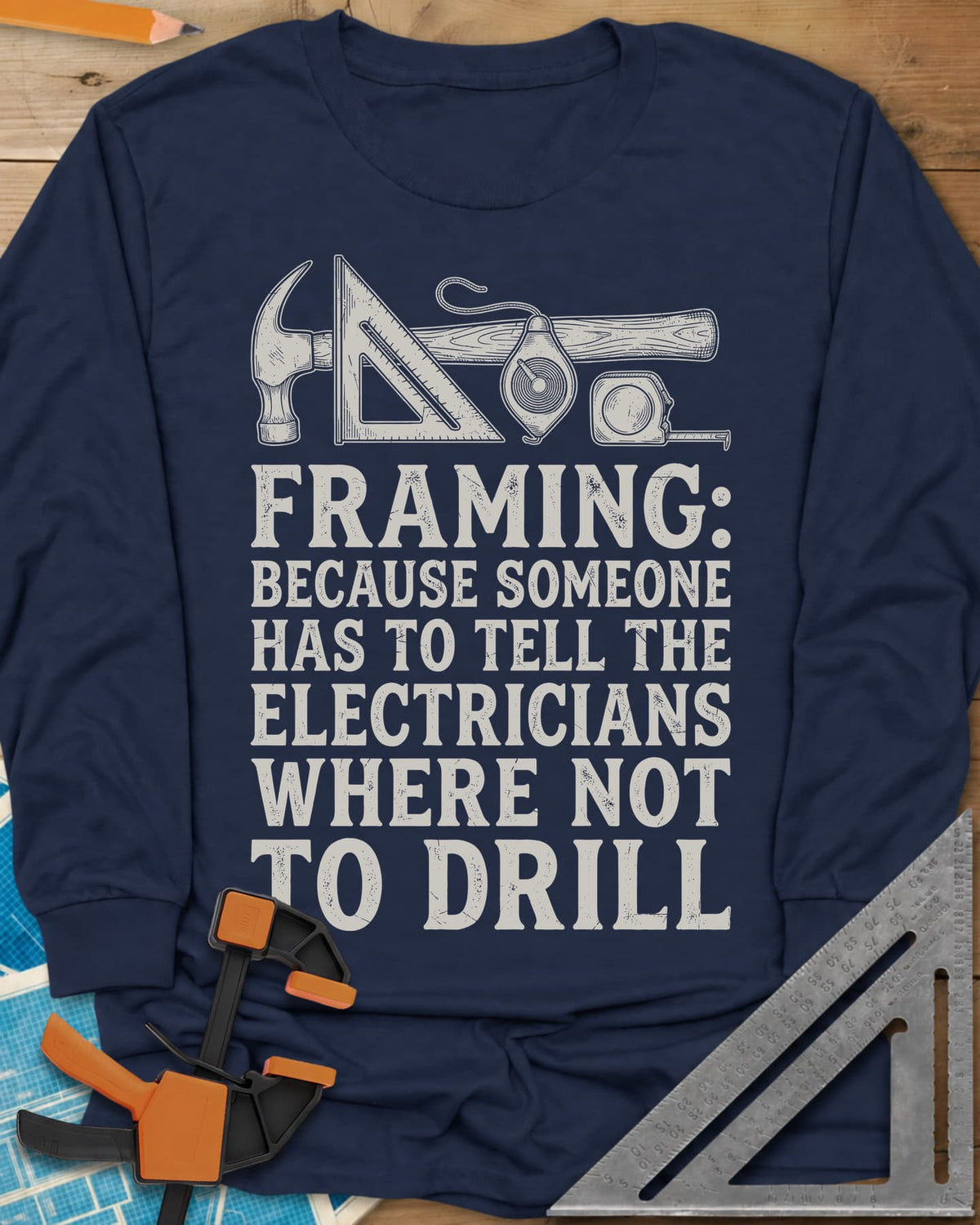 Framing long sleeve shirt in Navy, a hammer, speed square, chalk line reel and tape measure in a row