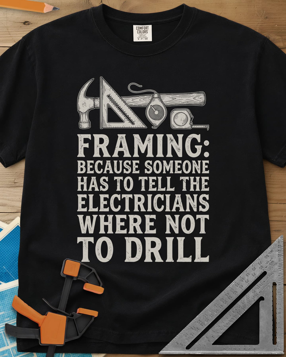 Framing heavyweight tee in Black, a hammer, speed square, chalk line reel and tape measure in a row