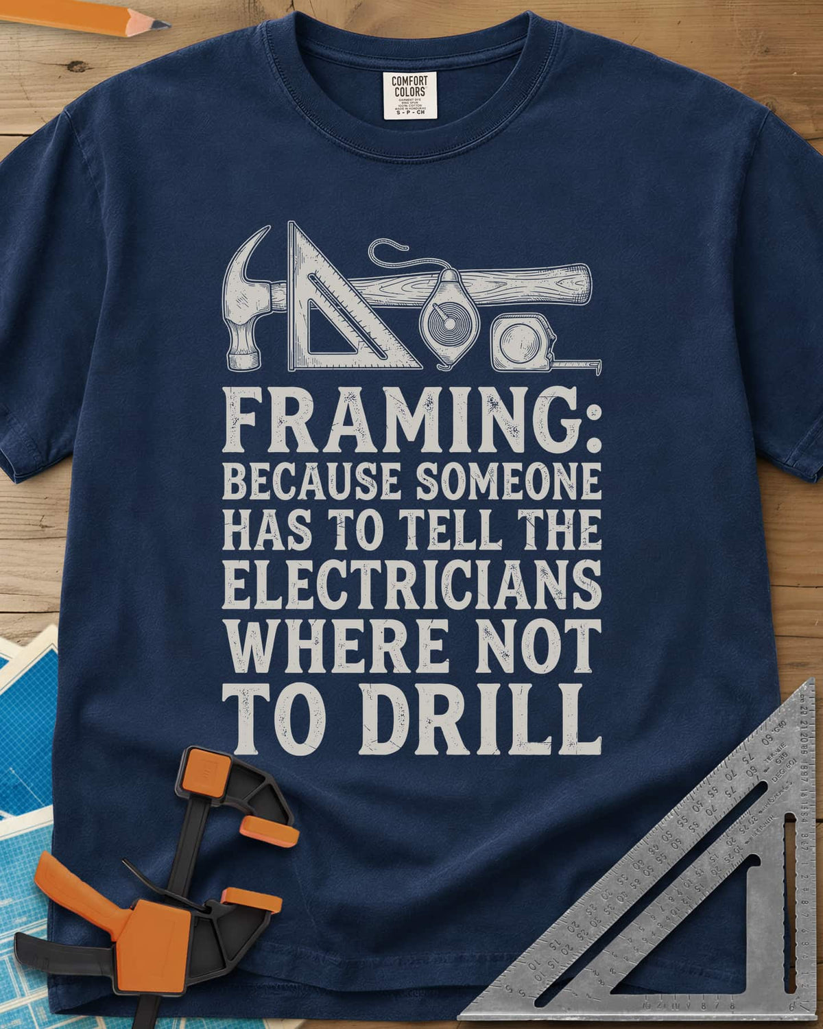 Framing heavyweight tee in Navy, a hammer, speed square, chalk line reel and tape measure in a row