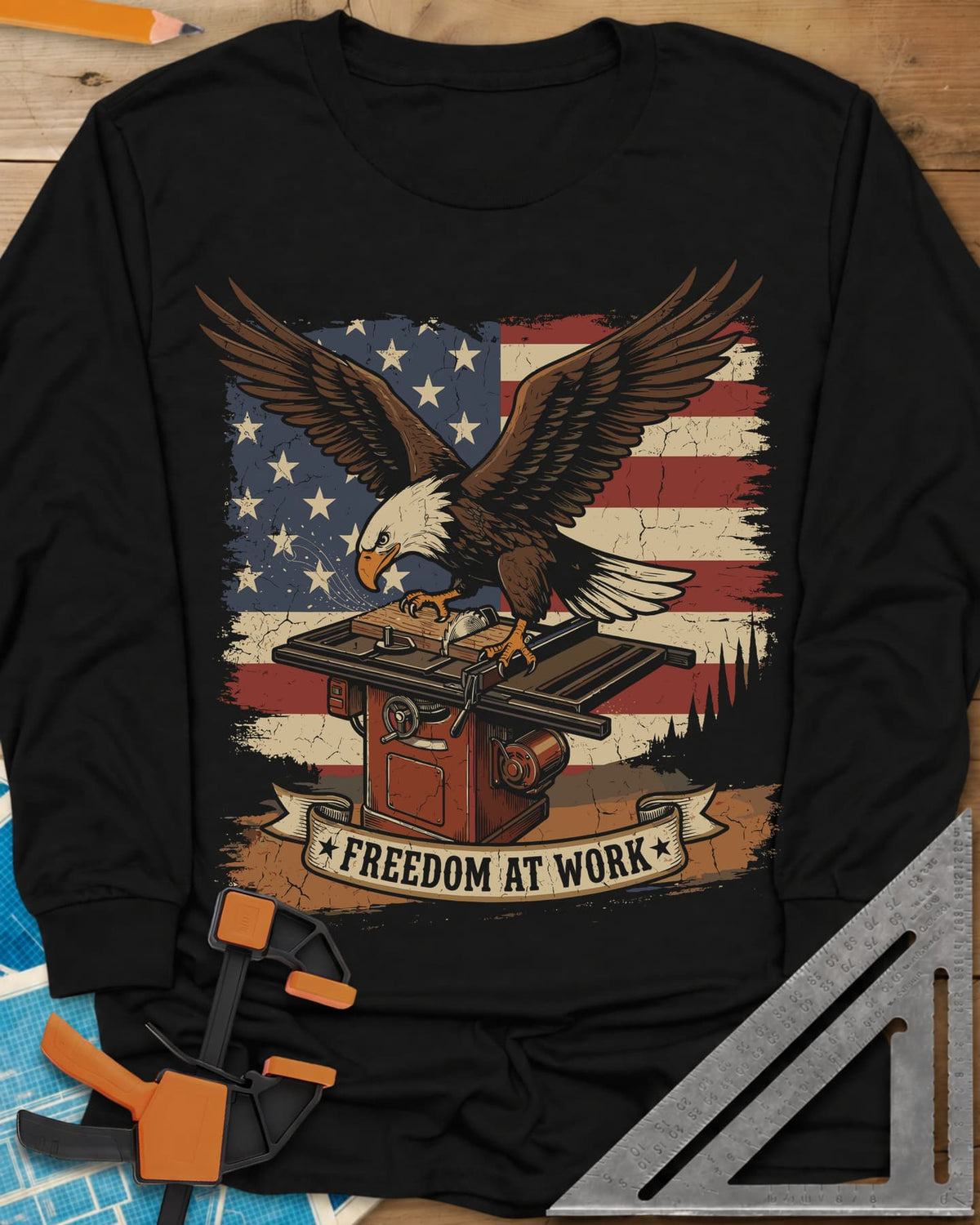 Freedom At Work Woodworking Eagle long sleeve shirt in Black, a bald eagle on a table saw in front of an American flag