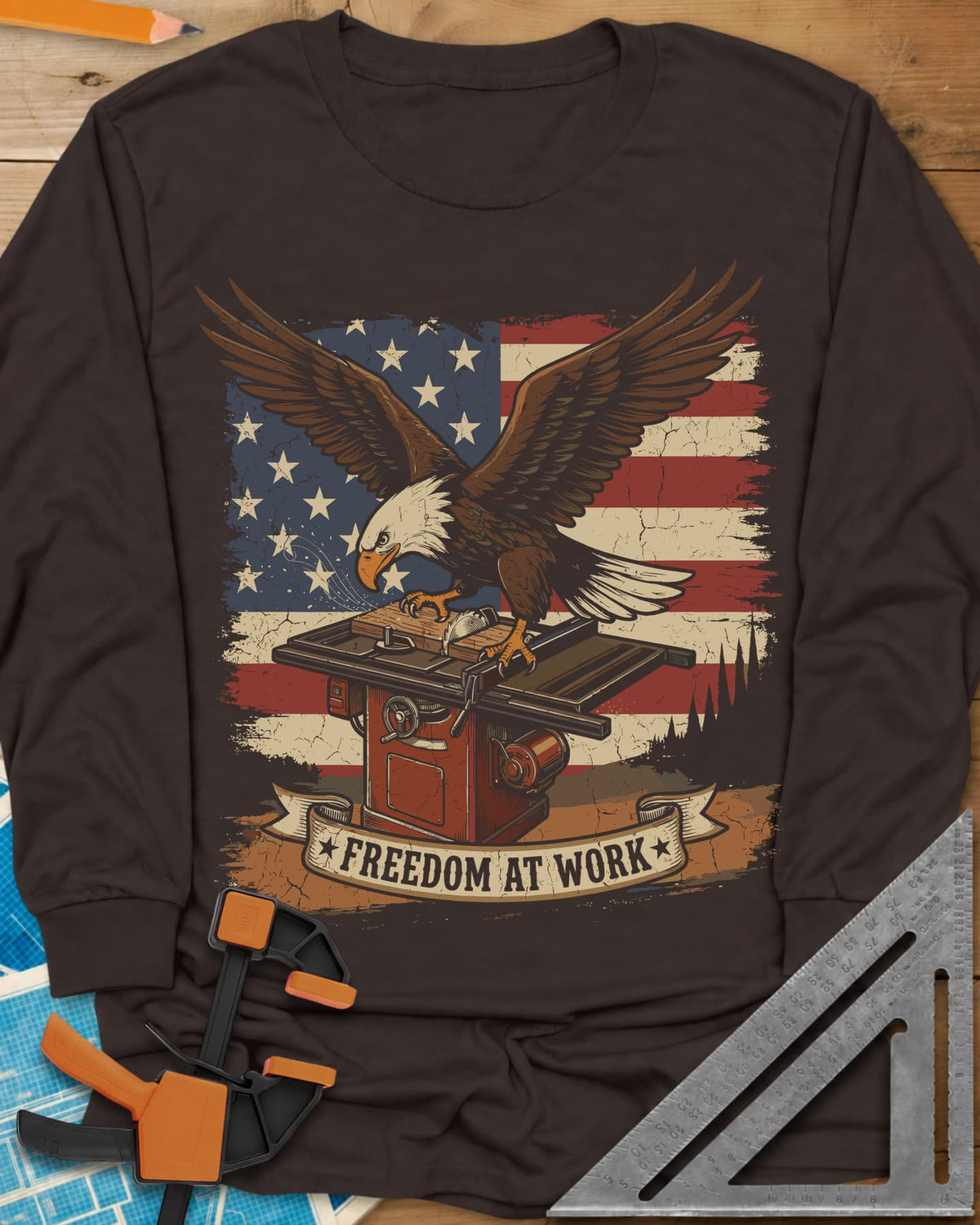 Freedom At Work Woodworking Eagle long sleeve shirt in Dark Chocolate, a bald eagle on a table saw in front of an American