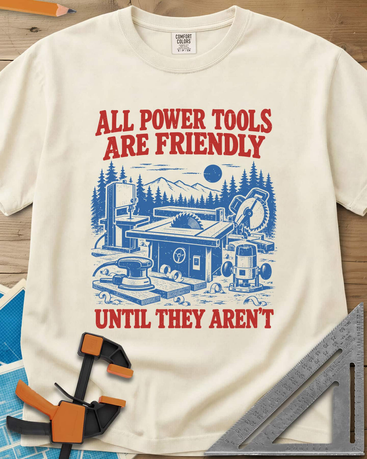Friendly Tools heavyweight tee in Ivory, a table saw, bandsaw, miter saw, sander and router in a forest
