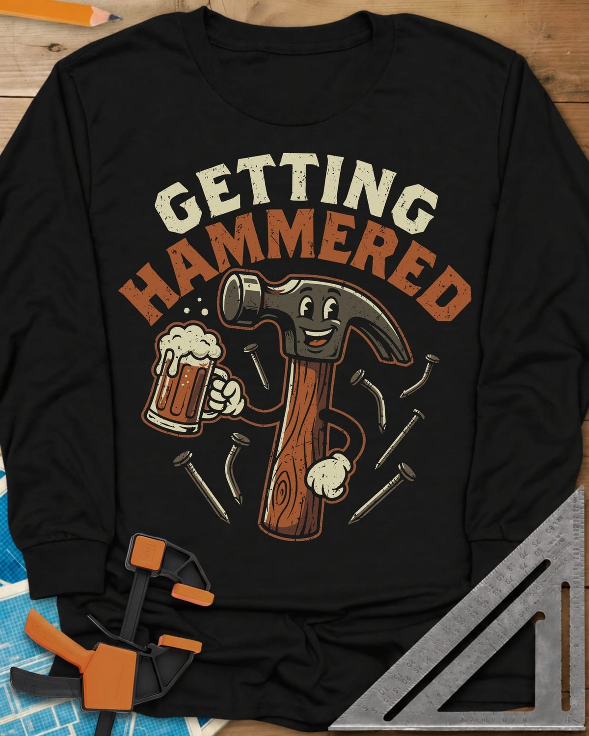 Getting Hammered long sleeve shirt in Black, a smiling cartoon hammer holding a beer mug, nails flying