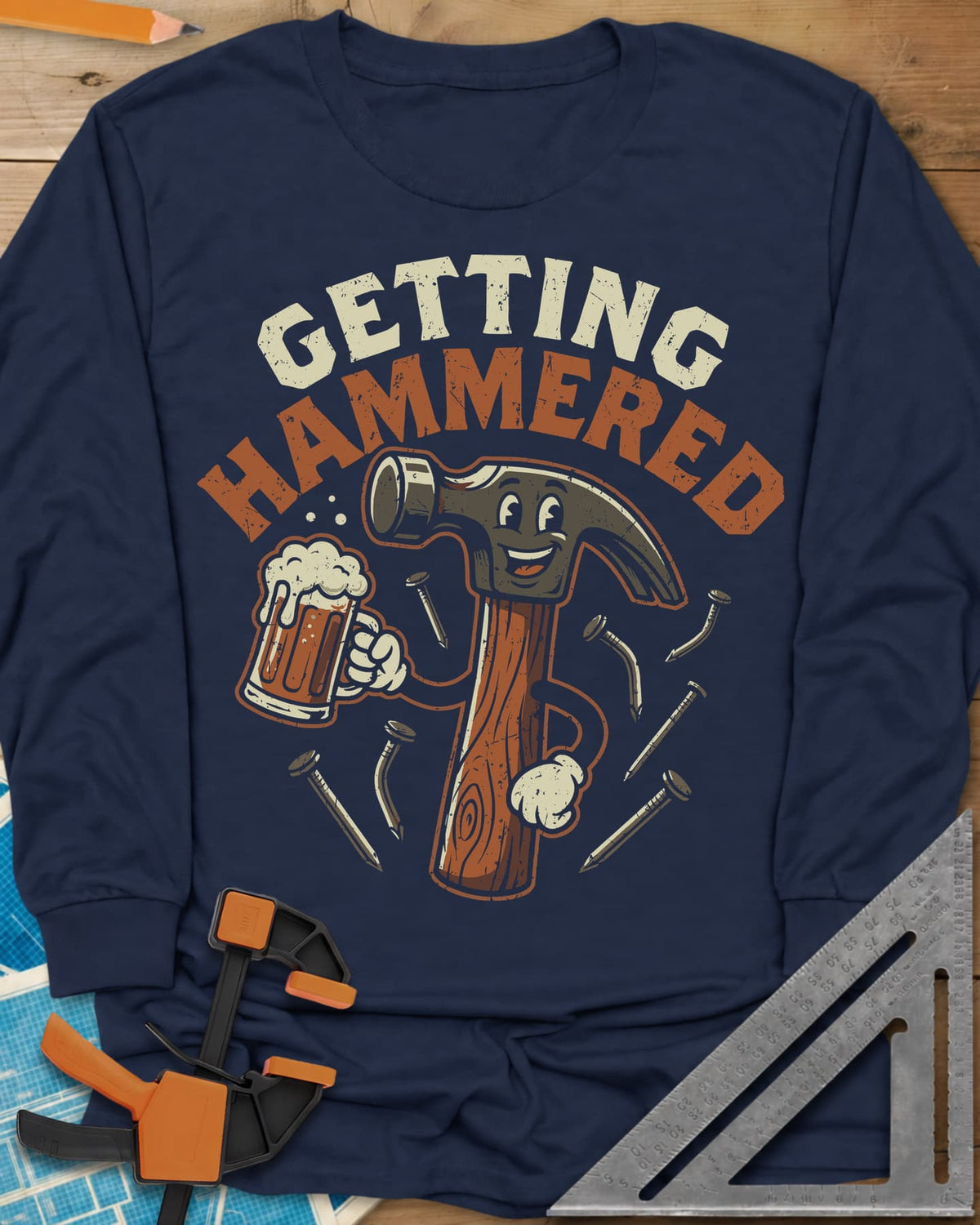 Getting Hammered long sleeve shirt in Navy, a smiling cartoon hammer holding a beer mug, nails flying