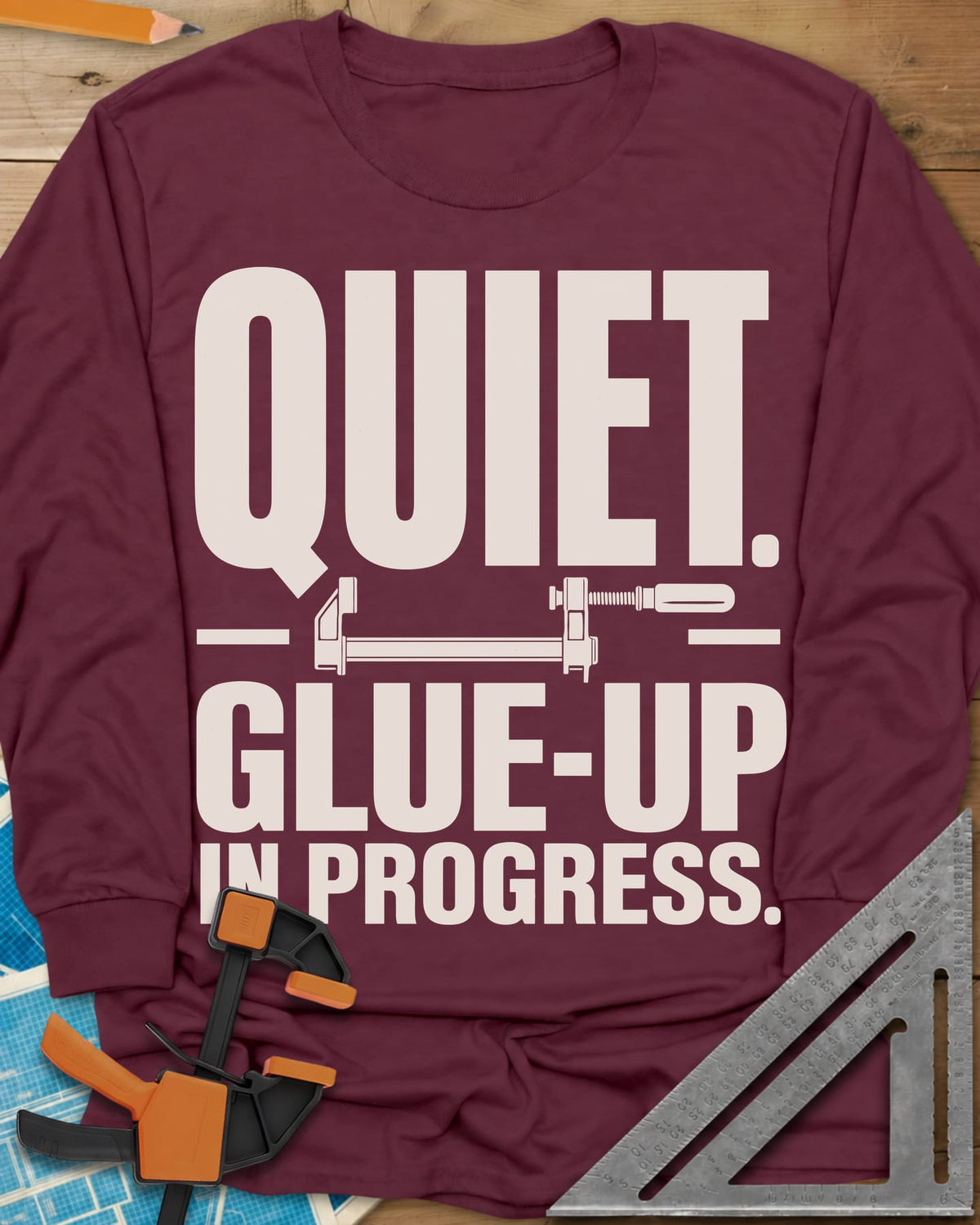Glue-Up long sleeve shirt in Maroon, a small bar clamp icon between bold lines of text