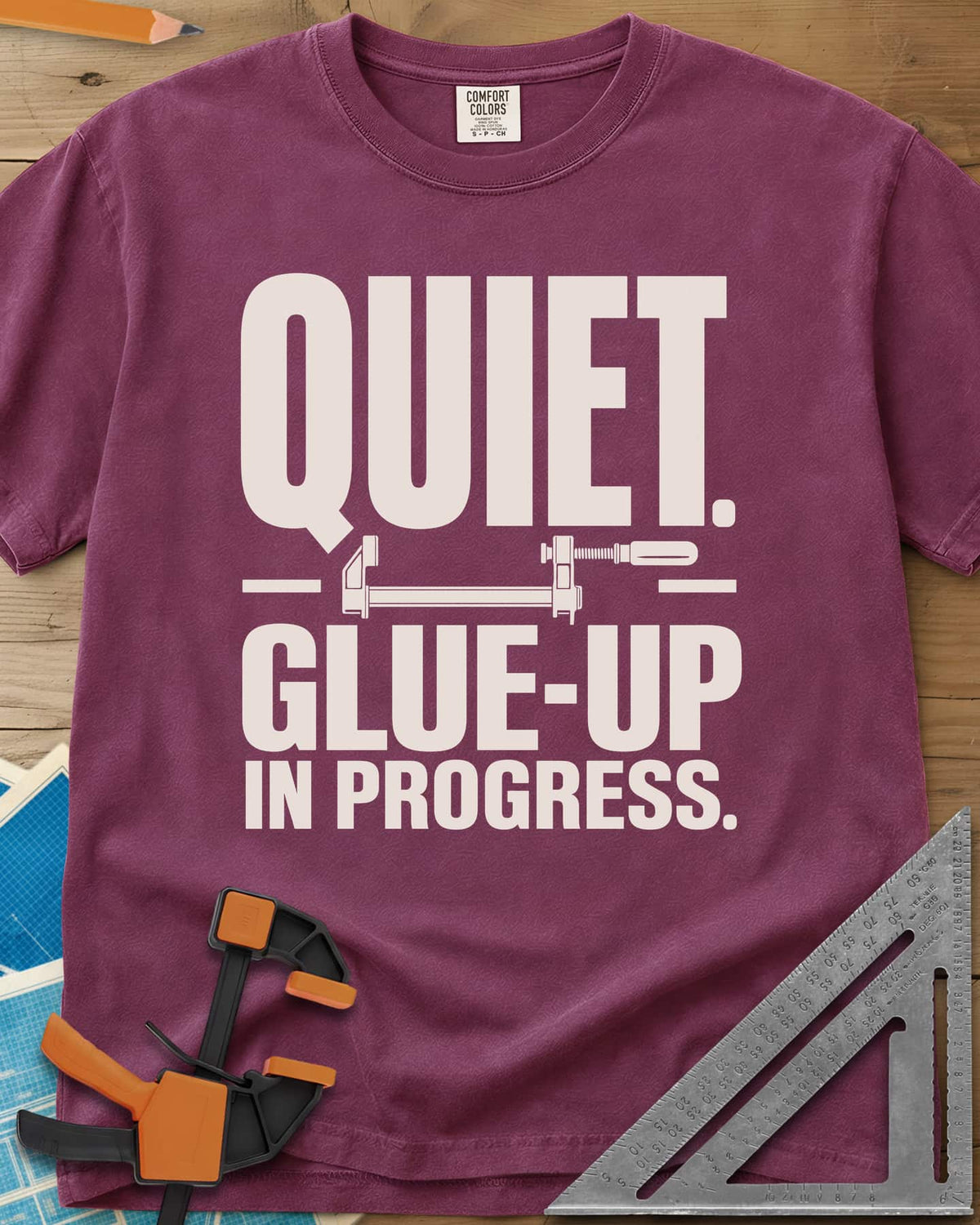 Glue-Up heavyweight tee in Berry, a small bar clamp icon between bold lines of text