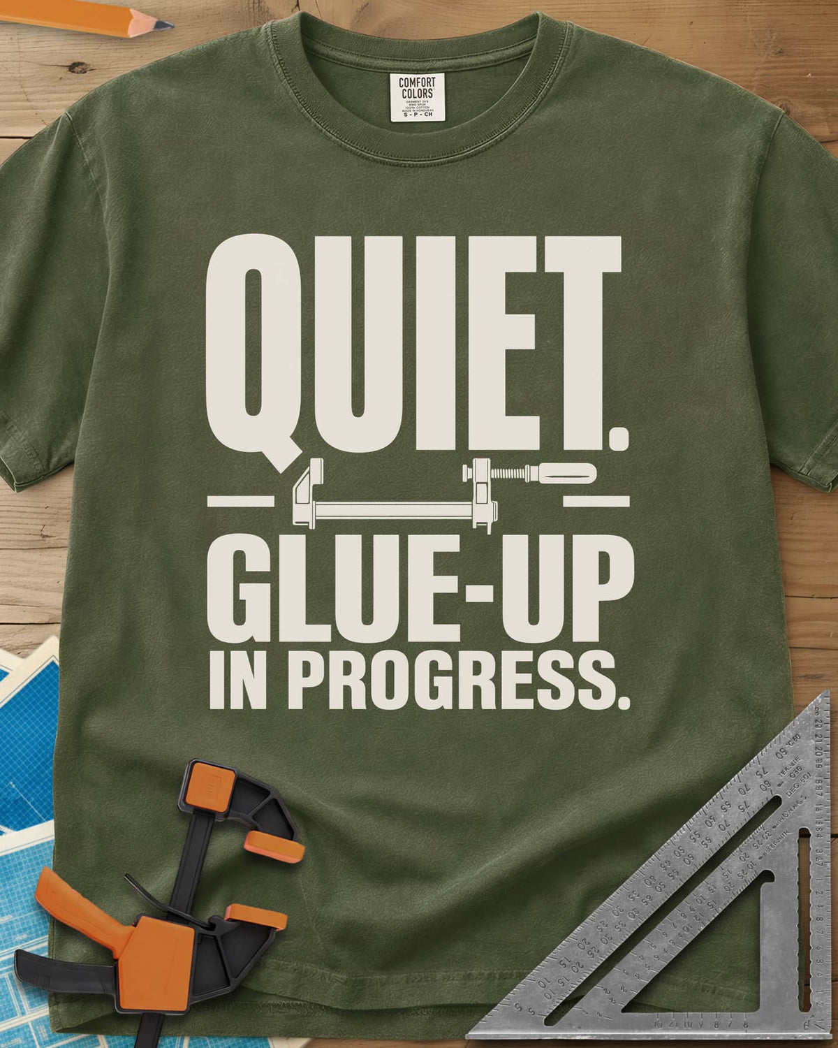 Glue-Up heavyweight tee in Hemp, a small bar clamp icon between bold lines of text