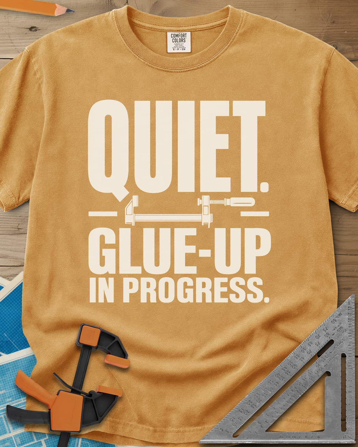 Glue-Up heavyweight tee in Mustard, a small bar clamp icon between bold lines of text