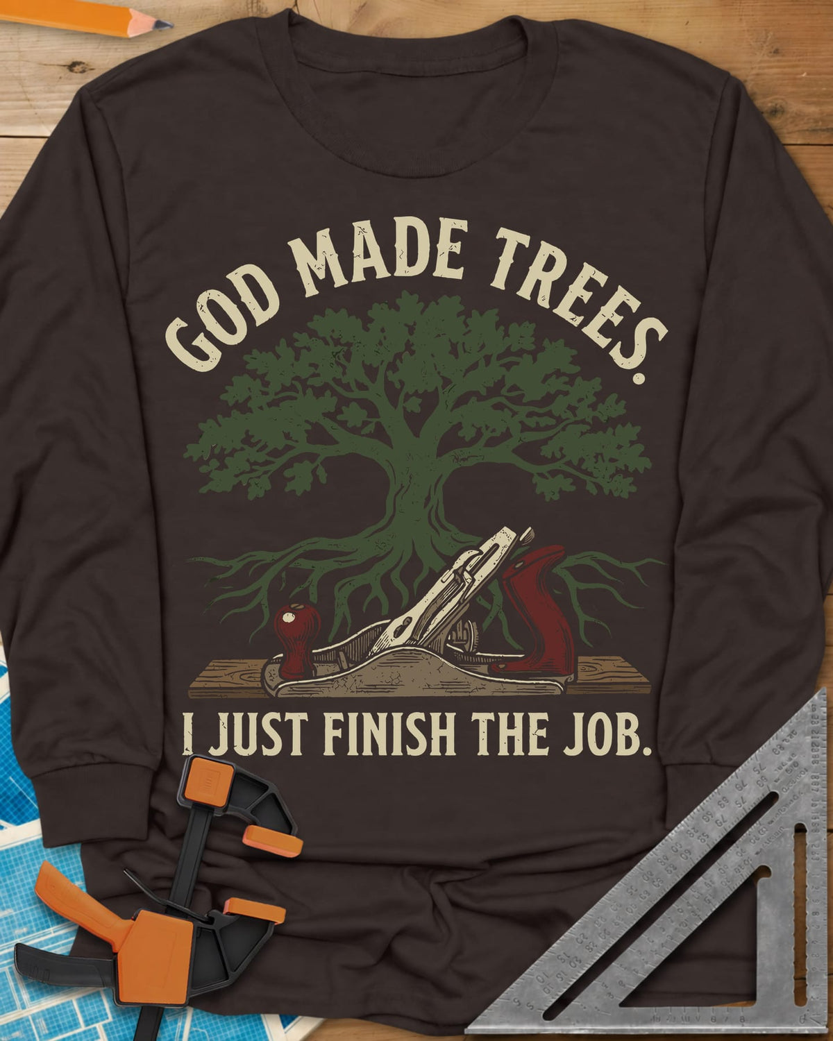 God Made Trees long sleeve shirt in Dark Chocolate, an oak tree with roots over a hand plane resting on a board