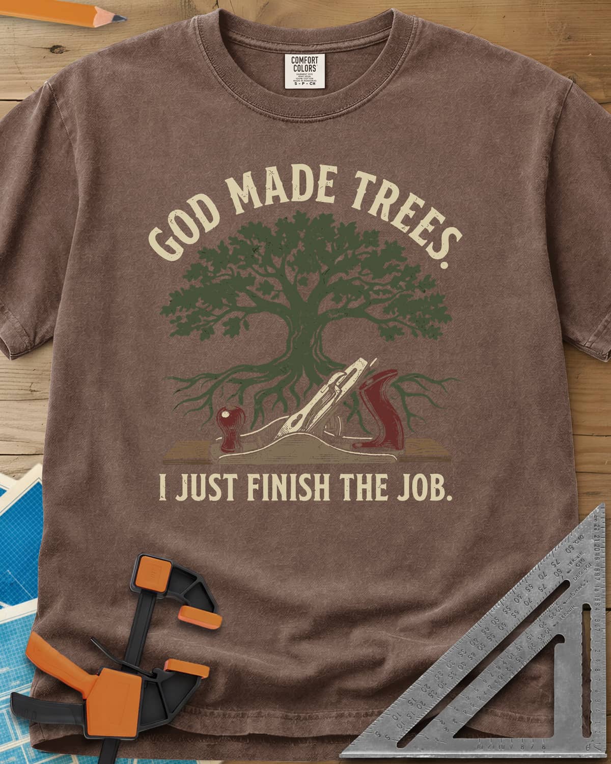God Made Trees heavyweight tee in Espresso, an oak tree with roots over a hand plane resting on a board