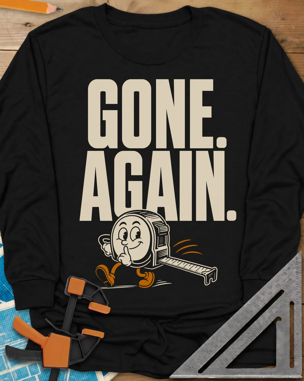 Gone Again long sleeve shirt in Black, a cartoon tape measure tiptoeing off with a finger to its lips
