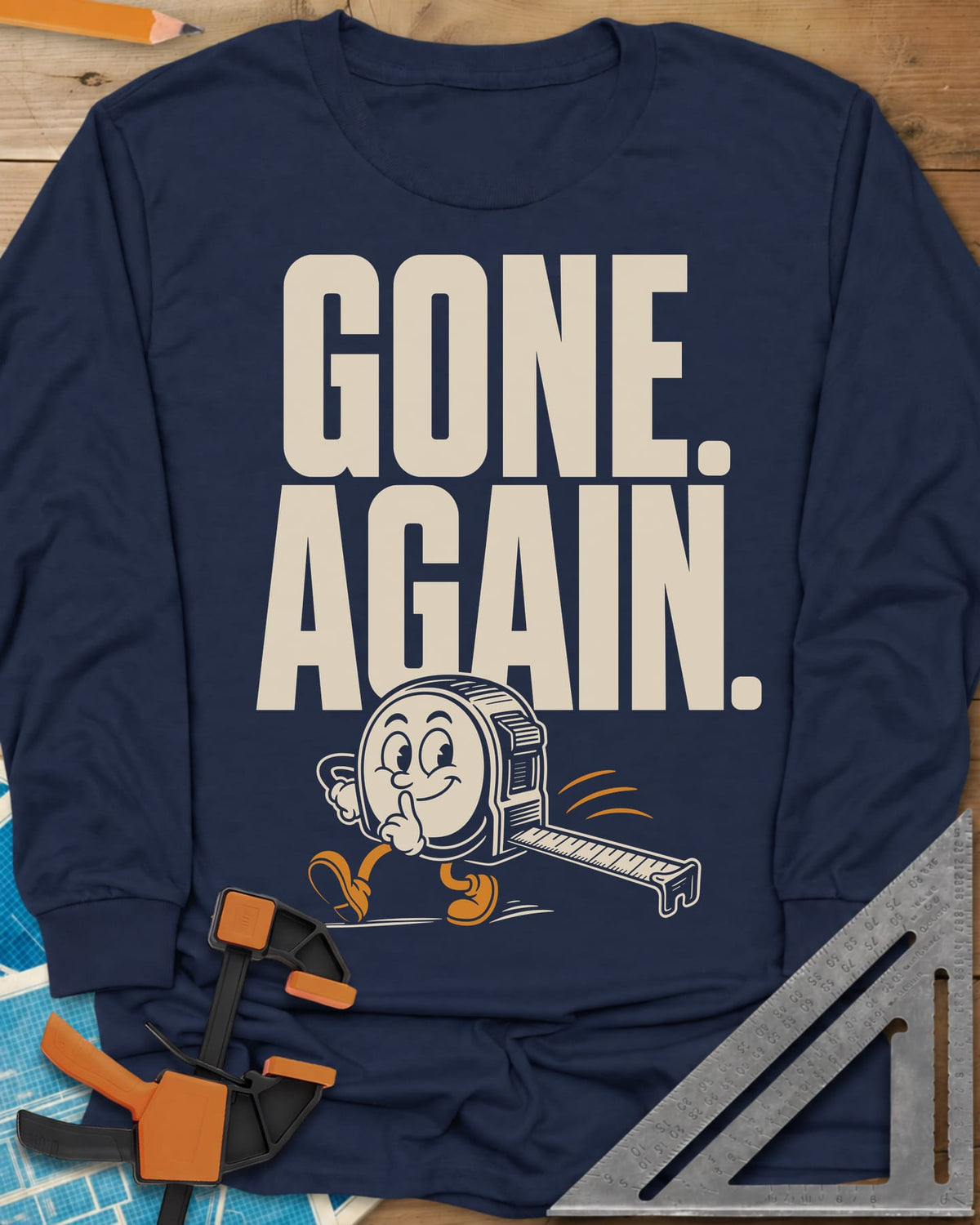 Gone Again long sleeve shirt in Navy, a cartoon tape measure tiptoeing off with a finger to its lips