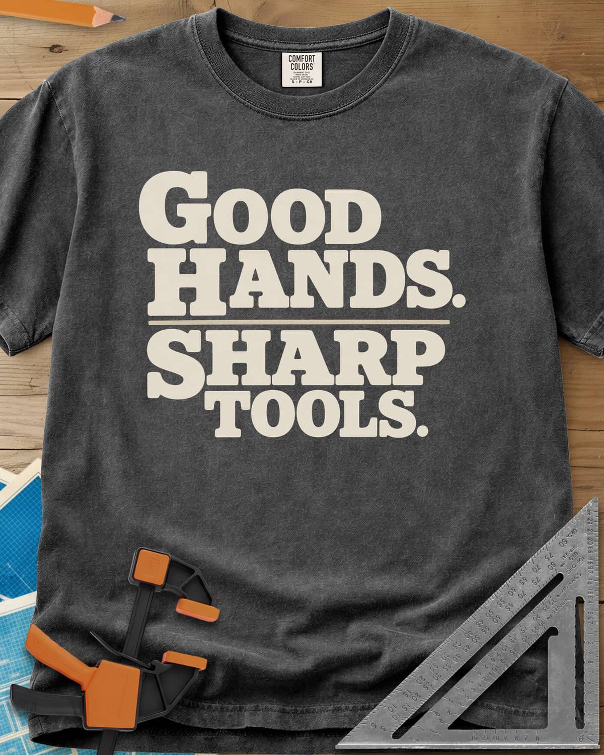 Good Hands heavyweight tee in Pepper, two lines of heavy slab-serif lettering split by a thin rule