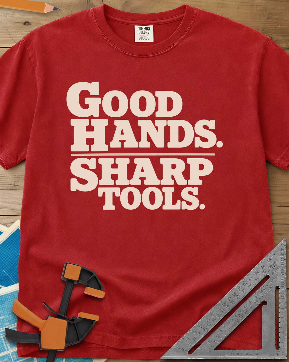 Good Hands heavyweight tee in Red, two lines of heavy slab-serif lettering split by a thin rule