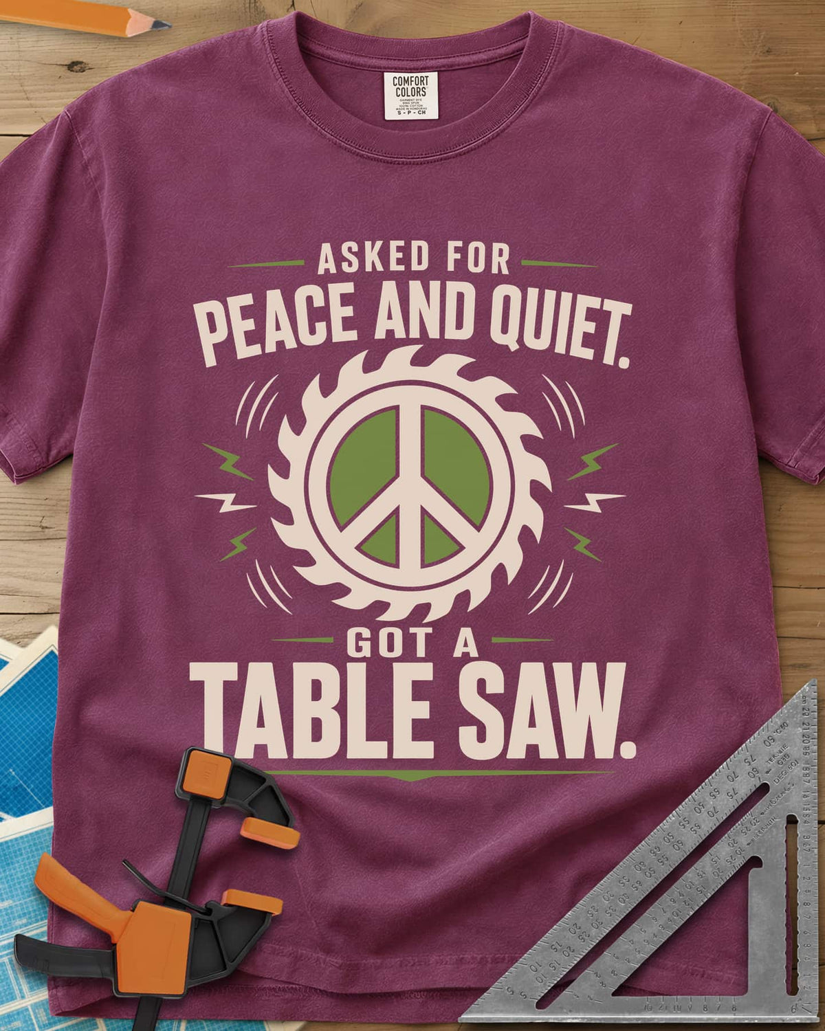 Got A Table Saw heavyweight tee in Berry, a peace sign inside a round saw blade with sound bursts