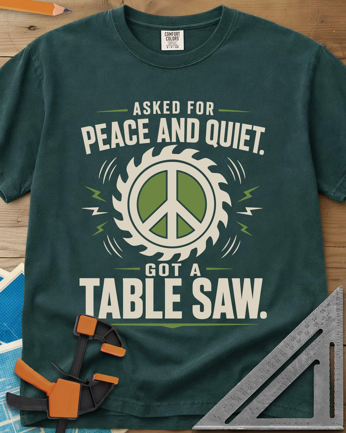 Got A Table Saw heavyweight tee in Blue Spruce, a peace sign inside a round saw blade with sound bursts