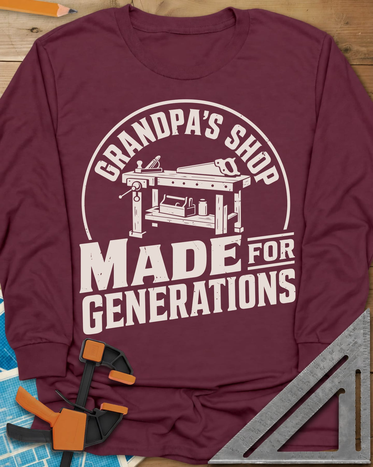 Grandpa'S Shop long sleeve shirt in Maroon, arched title over a workbench with a plane, handsaw and toolbox