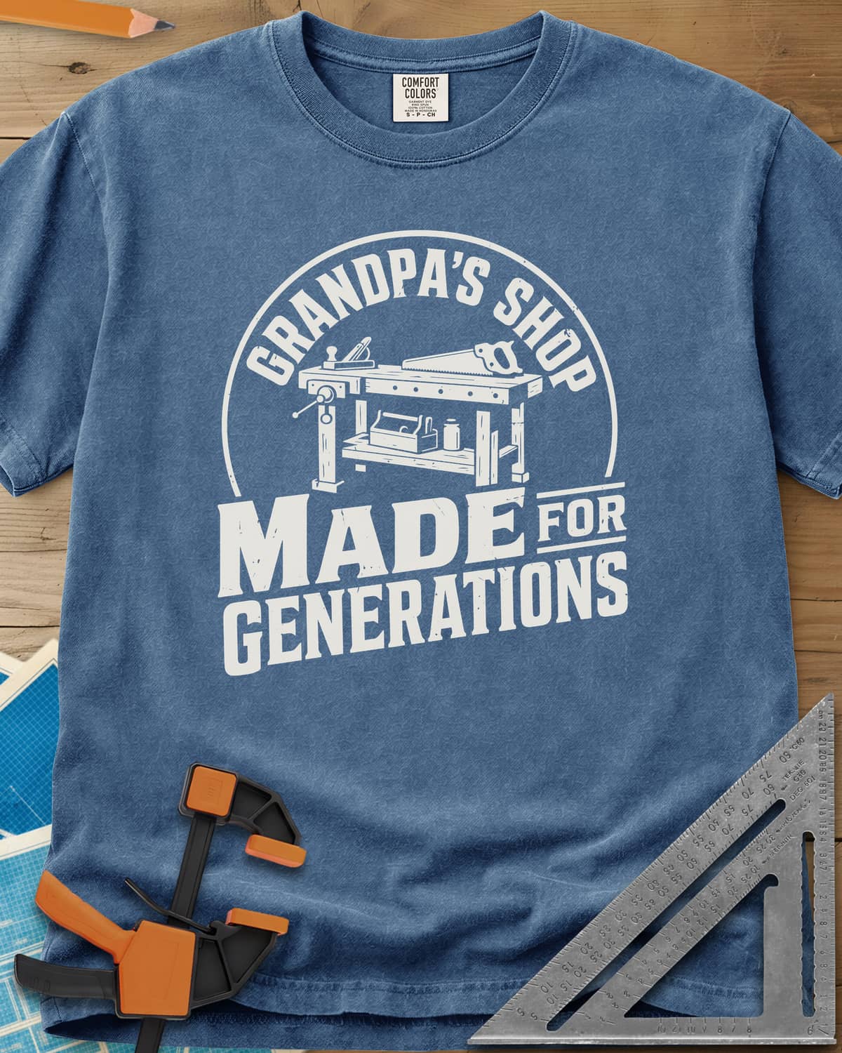 Grandpa'S Shop heavyweight tee in Blue Jean, arched title over a workbench with a plane, handsaw and toolbox