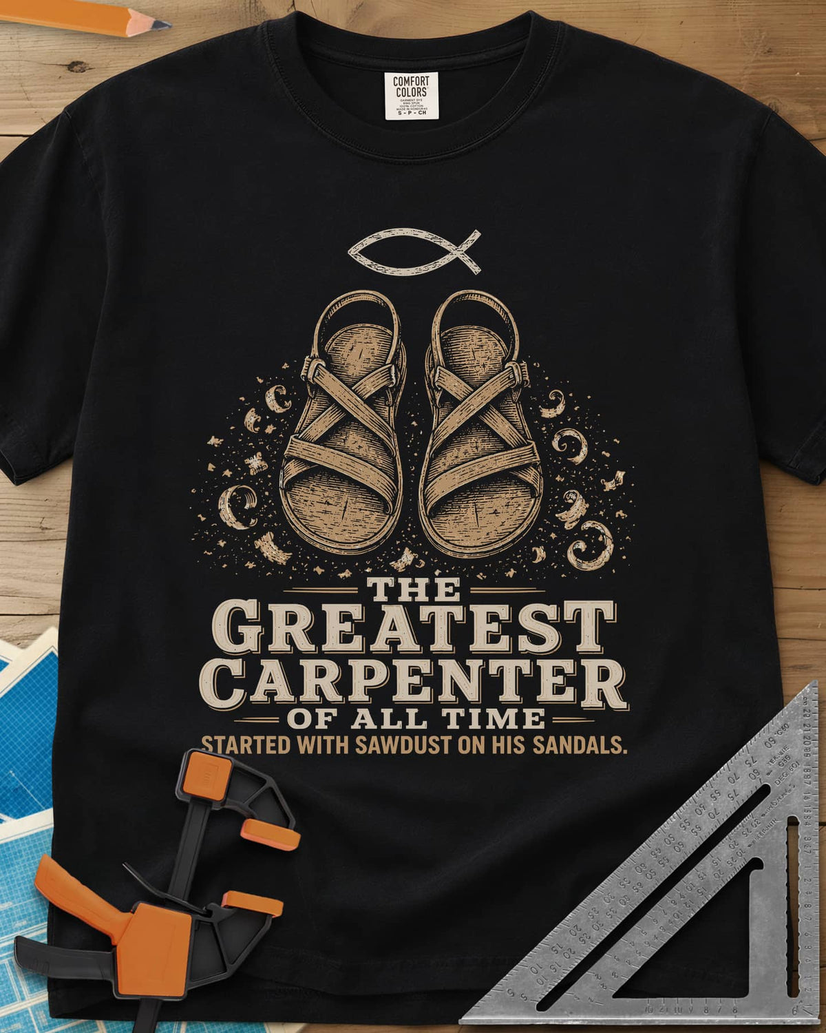 Greatest Carpenter heavyweight tee in Black, fish symbol over sandals dusted with wood shavings