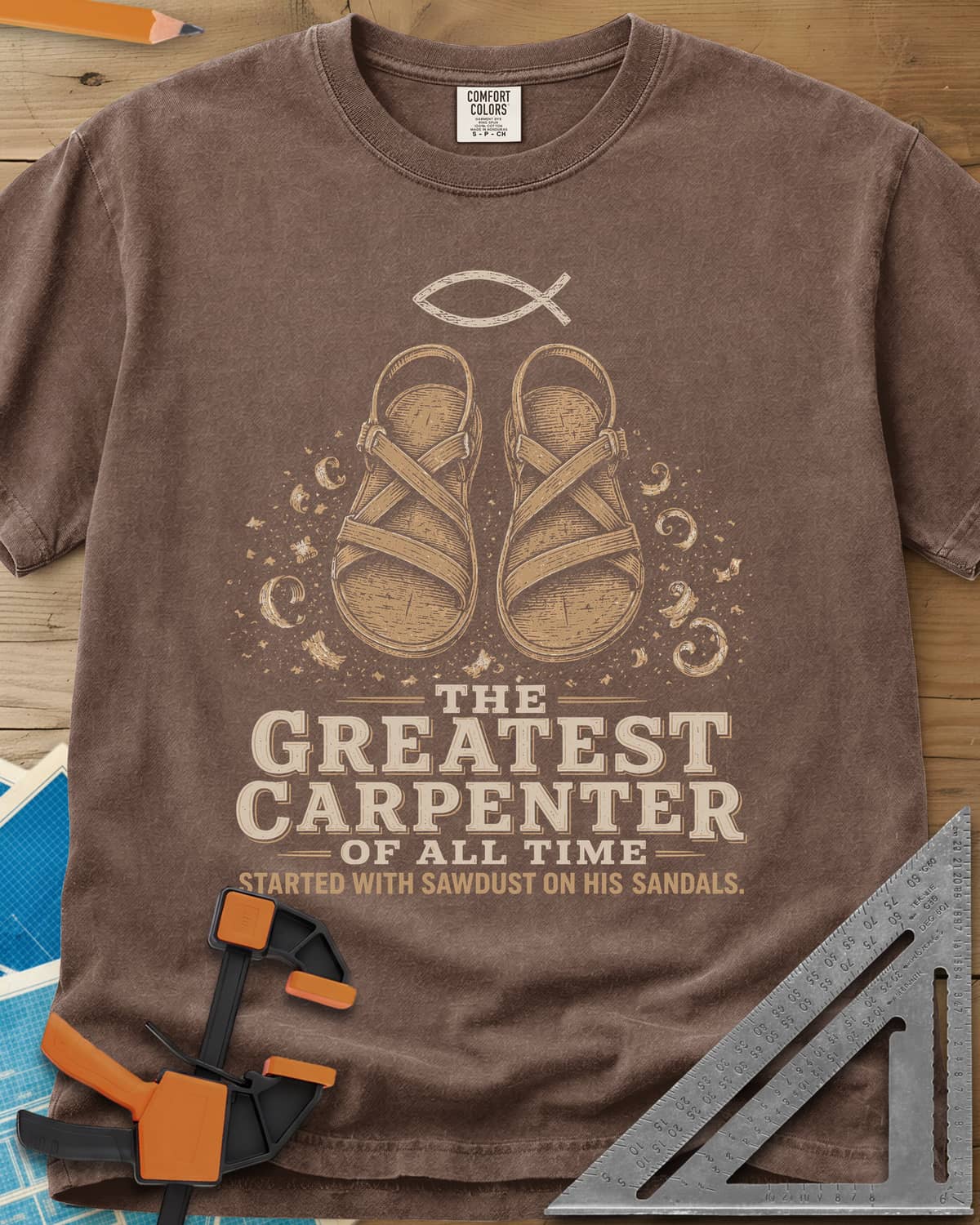 Greatest Carpenter heavyweight tee in Espresso, fish symbol over sandals dusted with wood shavings