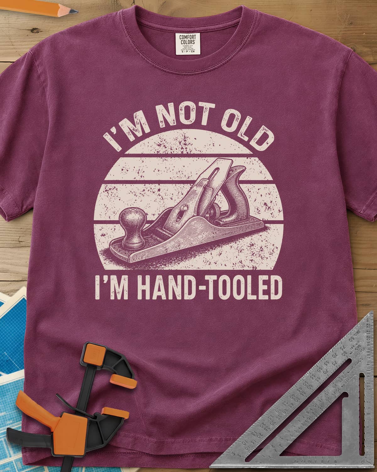 Hand Tooled heavyweight tee in Berry, a bench plane in a retro sunset circle