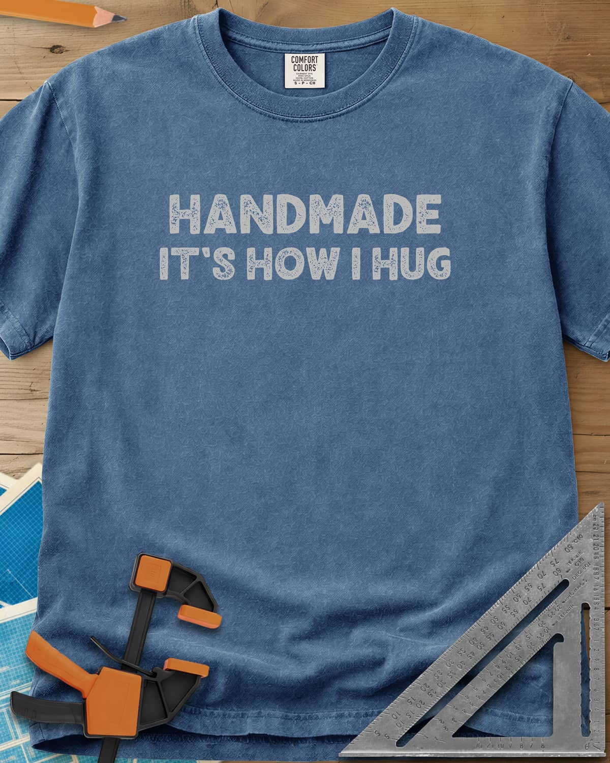 Handmade It's How I Hug heavyweight tee in Blue Jean, two lines of rough, distressed block lettering, no graphic
