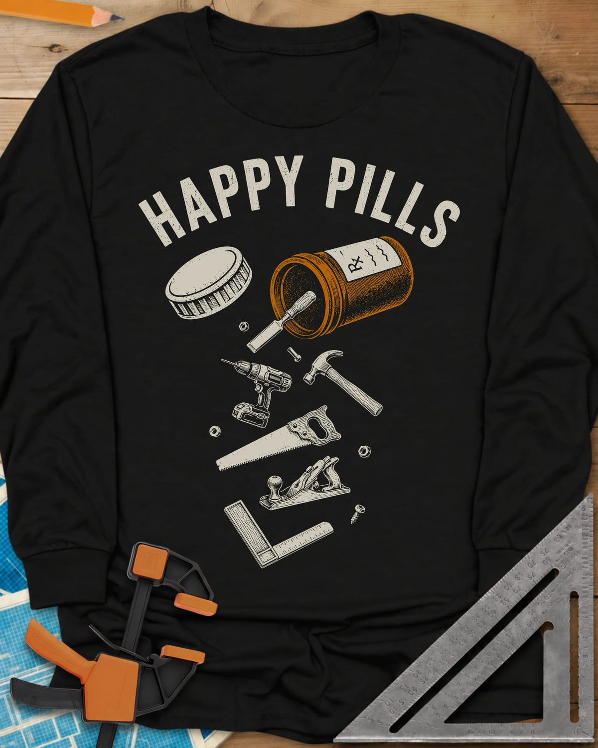 Happy Pills long sleeve shirt in Black, a tipped pill bottle spilling hand tools and a cordless drill