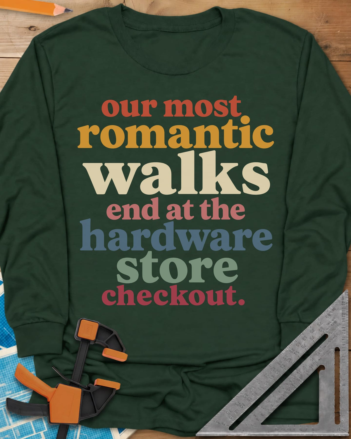 Hardware Store Checkout long sleeve shirt in Forest Green, stacked lowercase type in rust, mustard, cream, pink, blue and