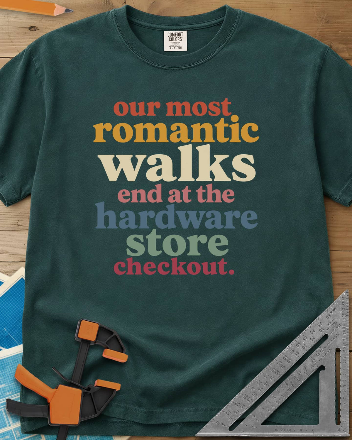Hardware Store Checkout heavyweight tee in Blue Spruce, stacked lowercase type in rust, mustard, cream, pink, blue and sage