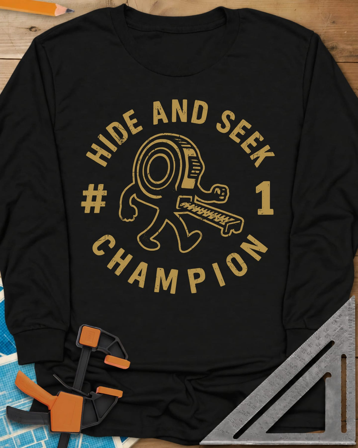 Hide And Seek long sleeve shirt in Black, a walking tape measure character inside a round badge