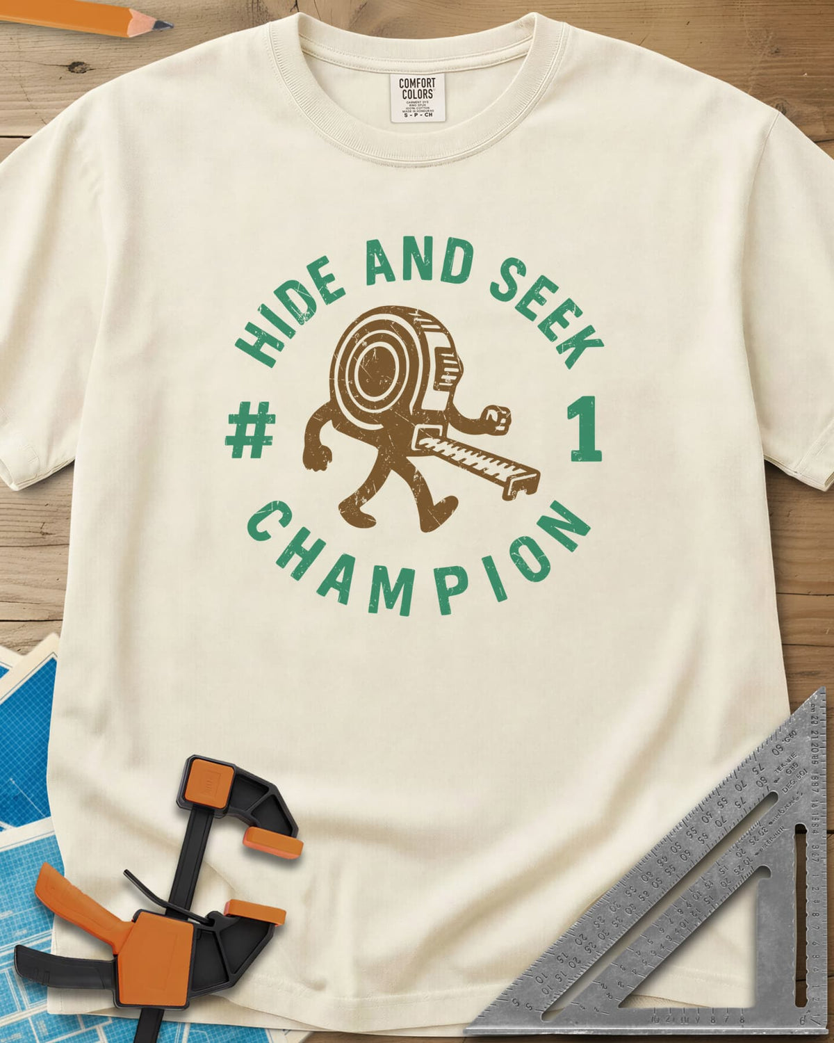 Hide And Seek heavyweight tee in Ivory, a walking tape measure character inside a round badge