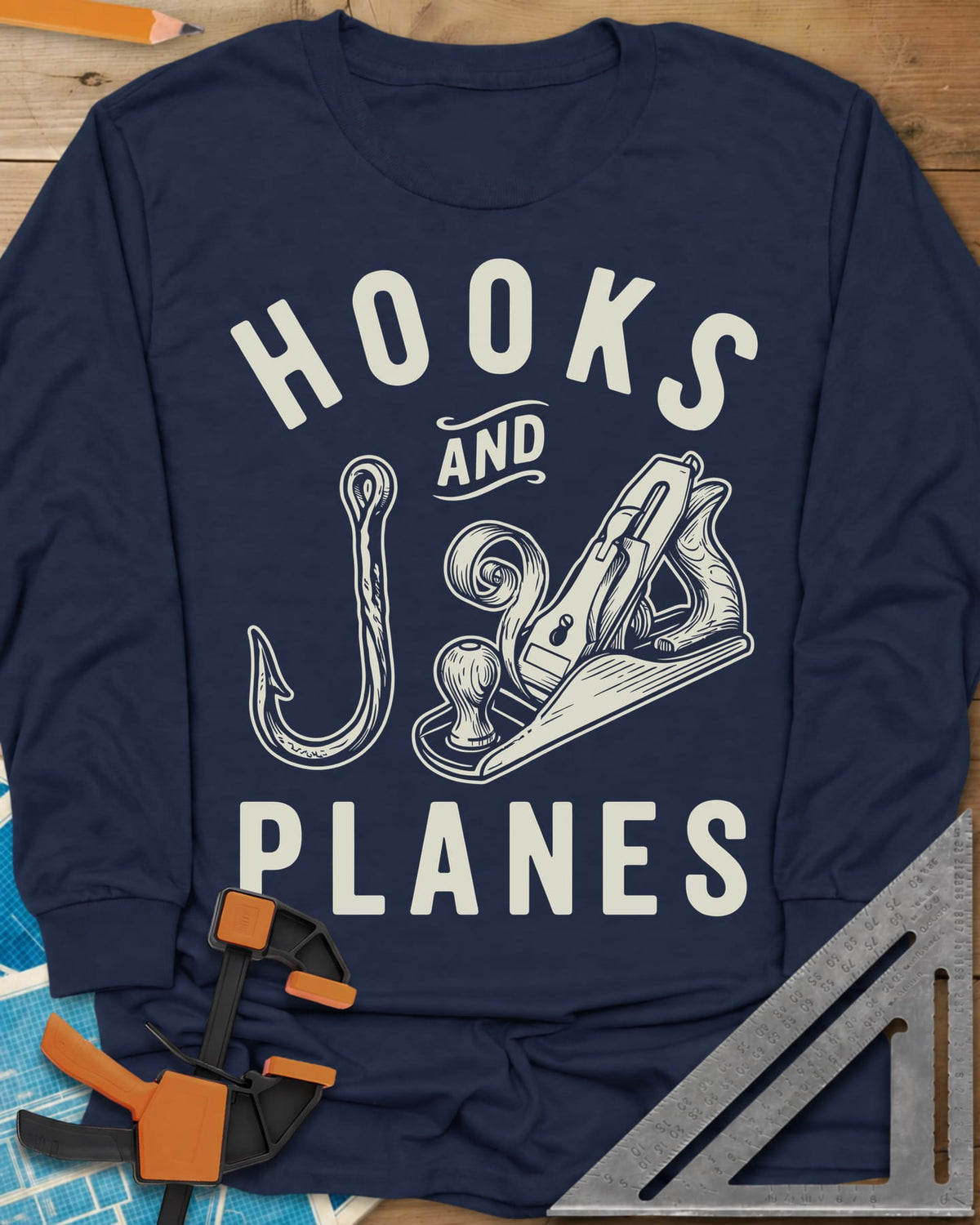 Hooks And Planes long sleeve shirt in Navy, an engraved fish hook and a hand plane with a curl of shavings