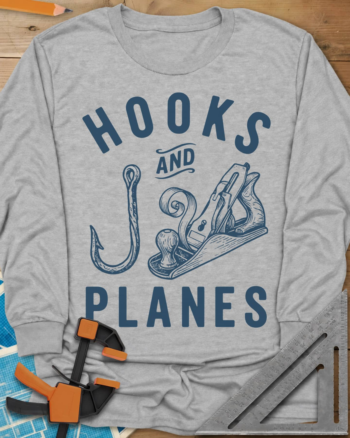 Hooks And Planes long sleeve shirt in Sport Grey, an engraved fish hook and a hand plane with a curl of shavings