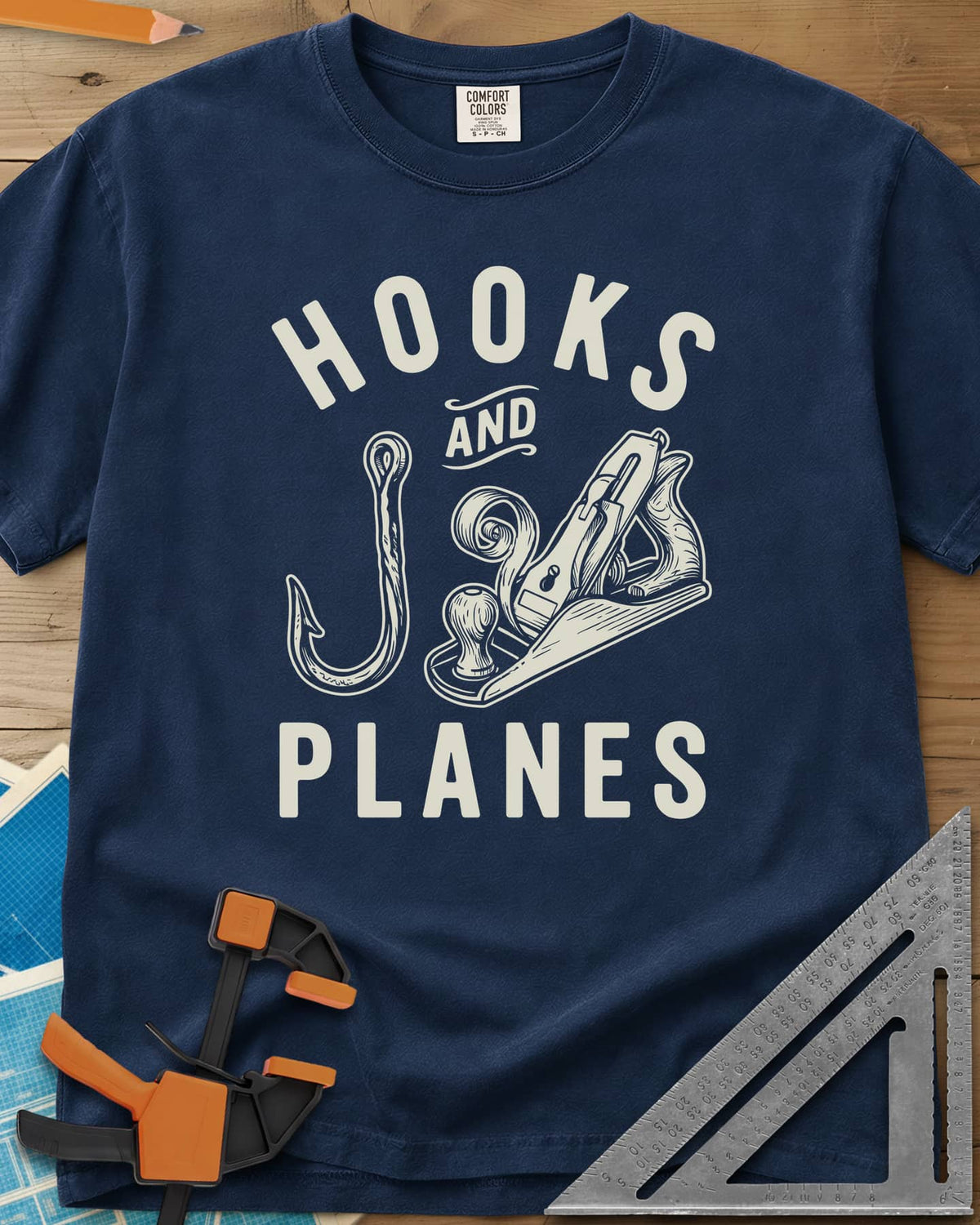 Hooks And Planes heavyweight tee in Navy, an engraved fish hook and a hand plane with a curl of shavings