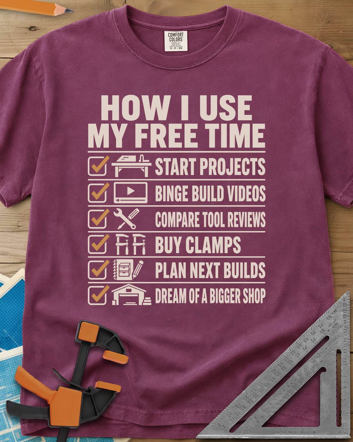 How I Use My Free Time heavyweight tee in Berry, six-line checklist, each tick beside a tiny icon