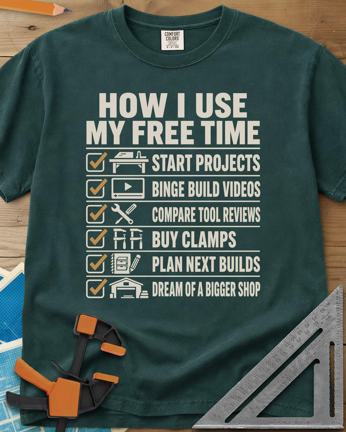 How I Use My Free Time heavyweight tee in Blue Spruce, six-line checklist, each tick beside a tiny icon