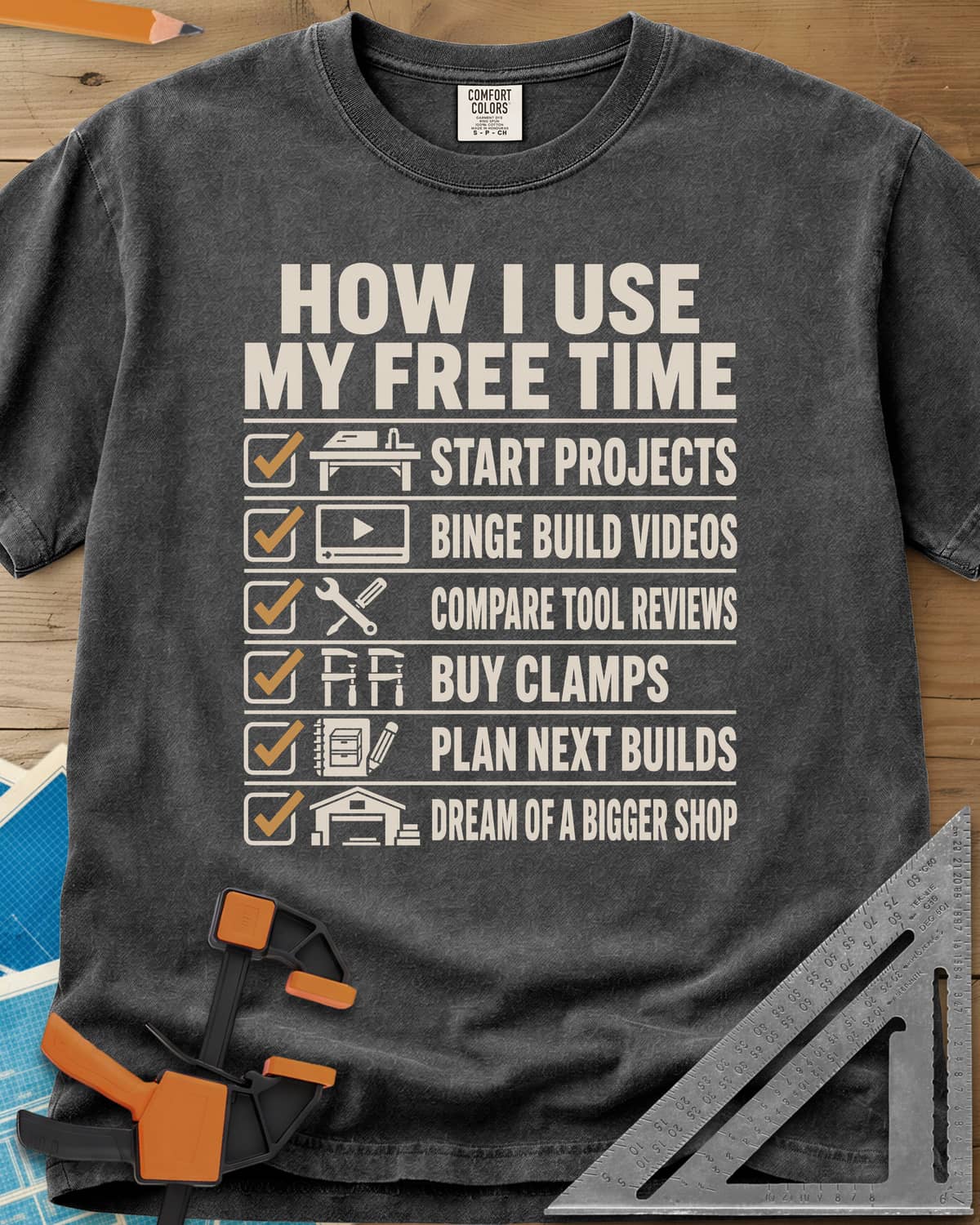How I Use My Free Time heavyweight tee in Pepper, six-line checklist, each tick beside a tiny icon