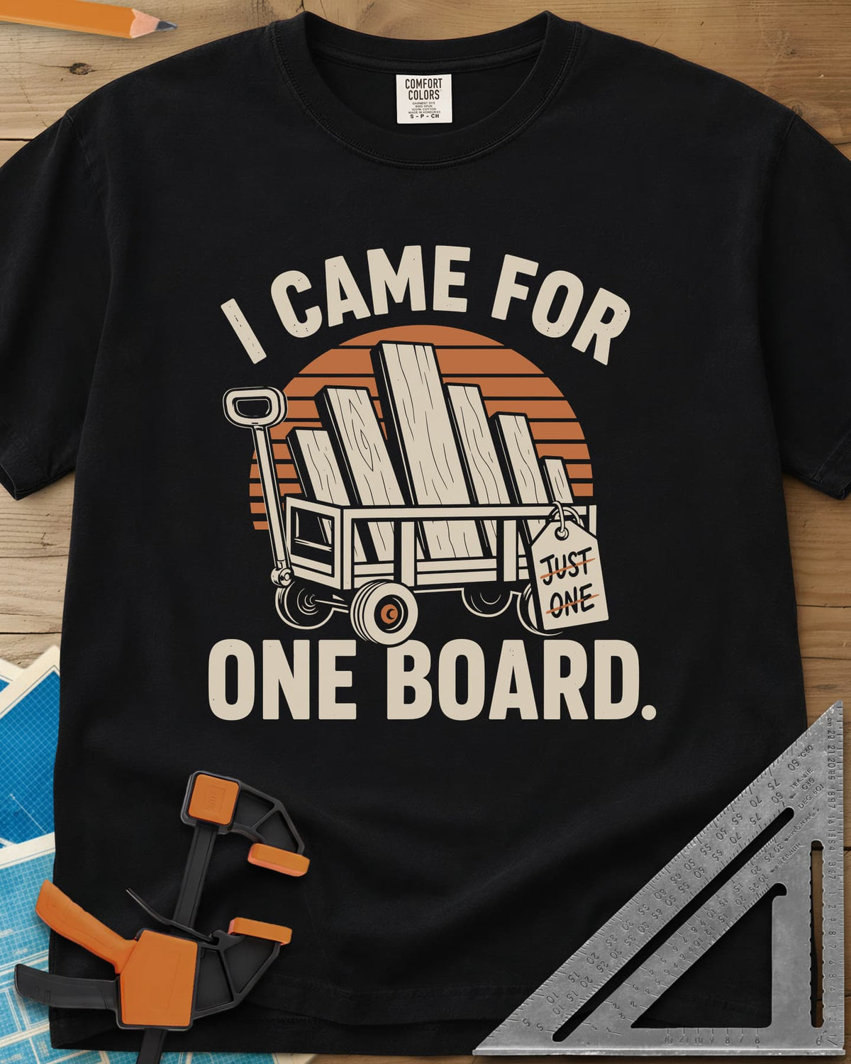 I Came For One Board heavyweight tee in Black, a wagon stacked with boards and a struck-out JUST ONE tag