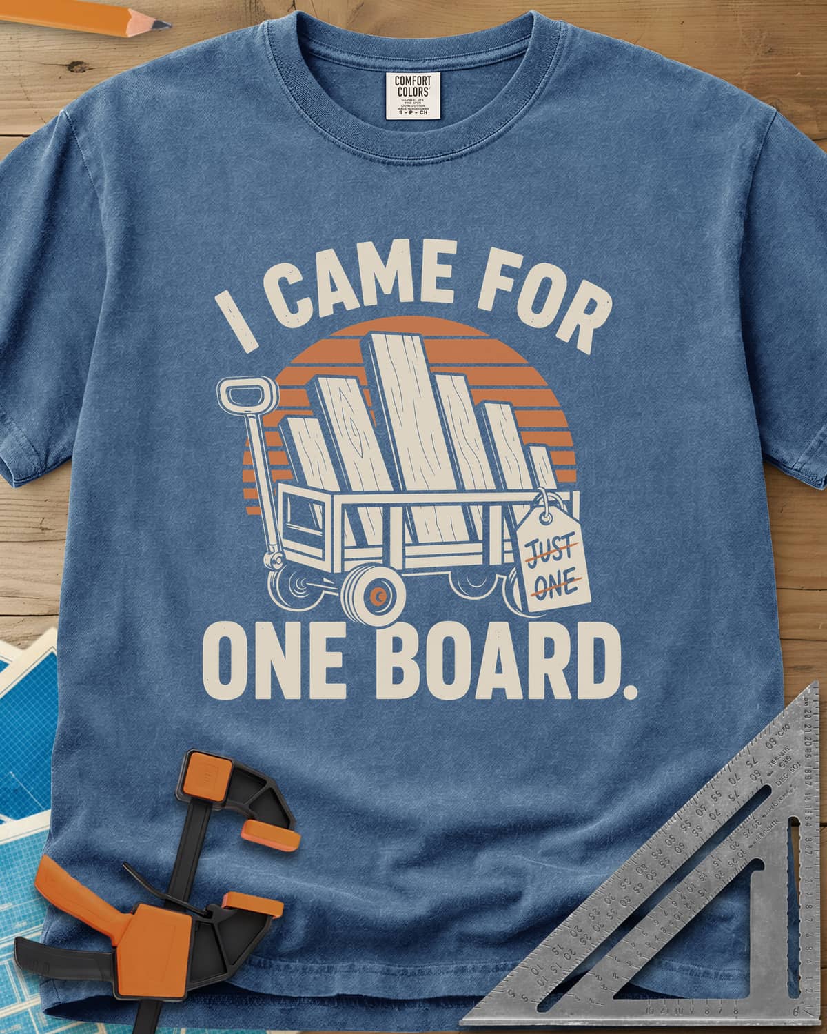 I Came For One Board heavyweight tee in Blue Jean, a wagon stacked with boards and a struck-out JUST ONE tag