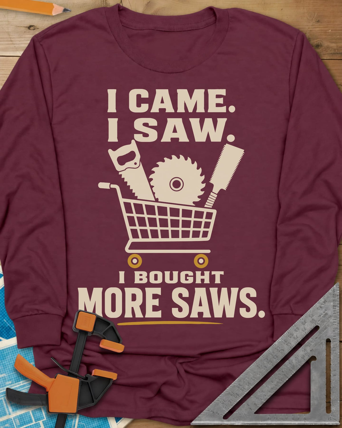 I Came I Saw I Bought More Saws long sleeve shirt in Maroon, a shopping cart holding a handsaw, a saw blade and a pull saw