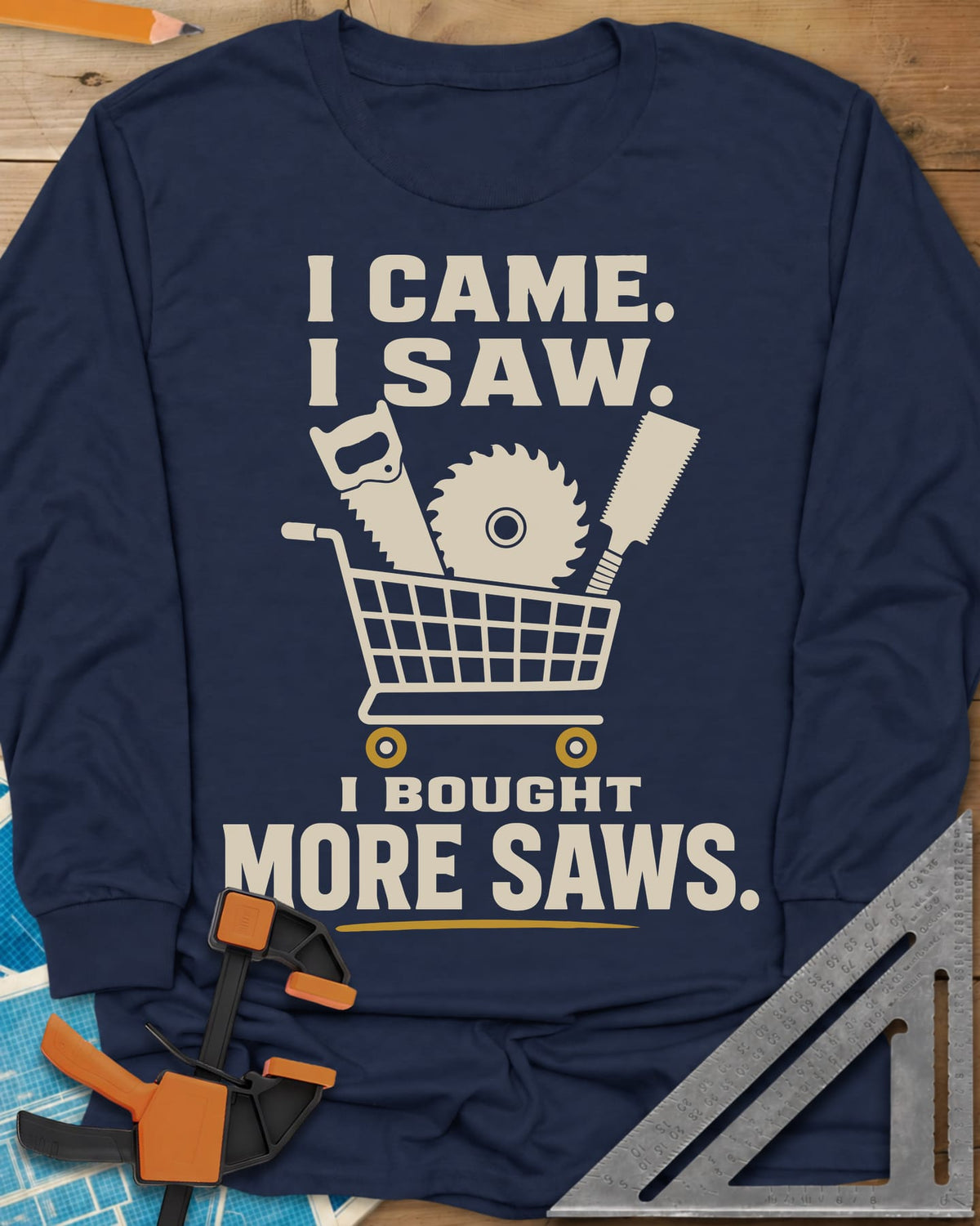 I Came I Saw I Bought More Saws long sleeve shirt in Navy, a shopping cart holding a handsaw, a saw blade and a pull saw