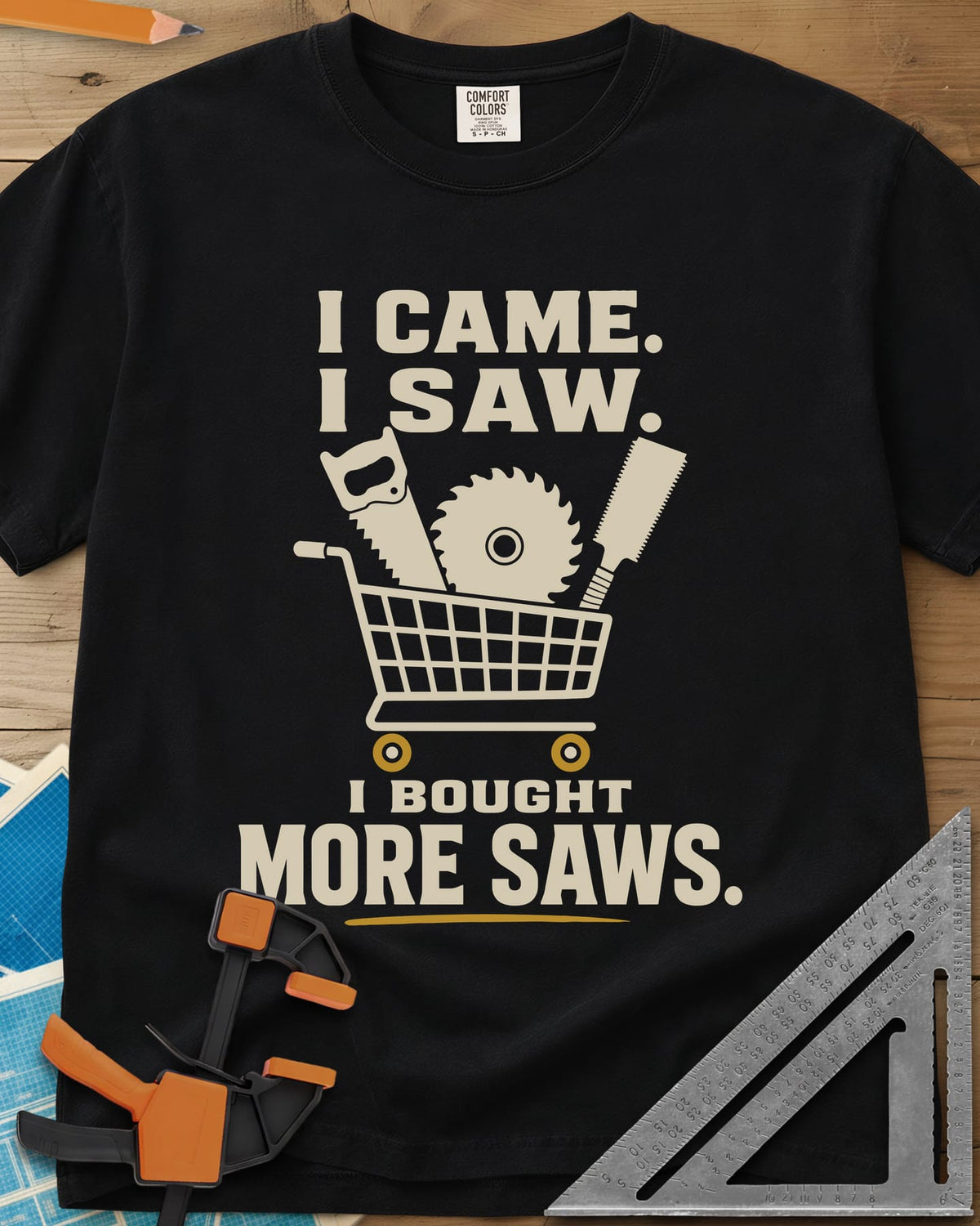 I Came I Saw I Bought More Saws heavyweight tee in Black, a shopping cart holding a handsaw, a saw blade and a pull saw