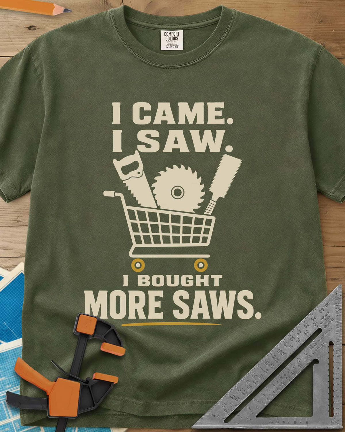 I Came I Saw I Bought More Saws heavyweight tee in Hemp, a shopping cart holding a handsaw, a saw blade and a pull saw