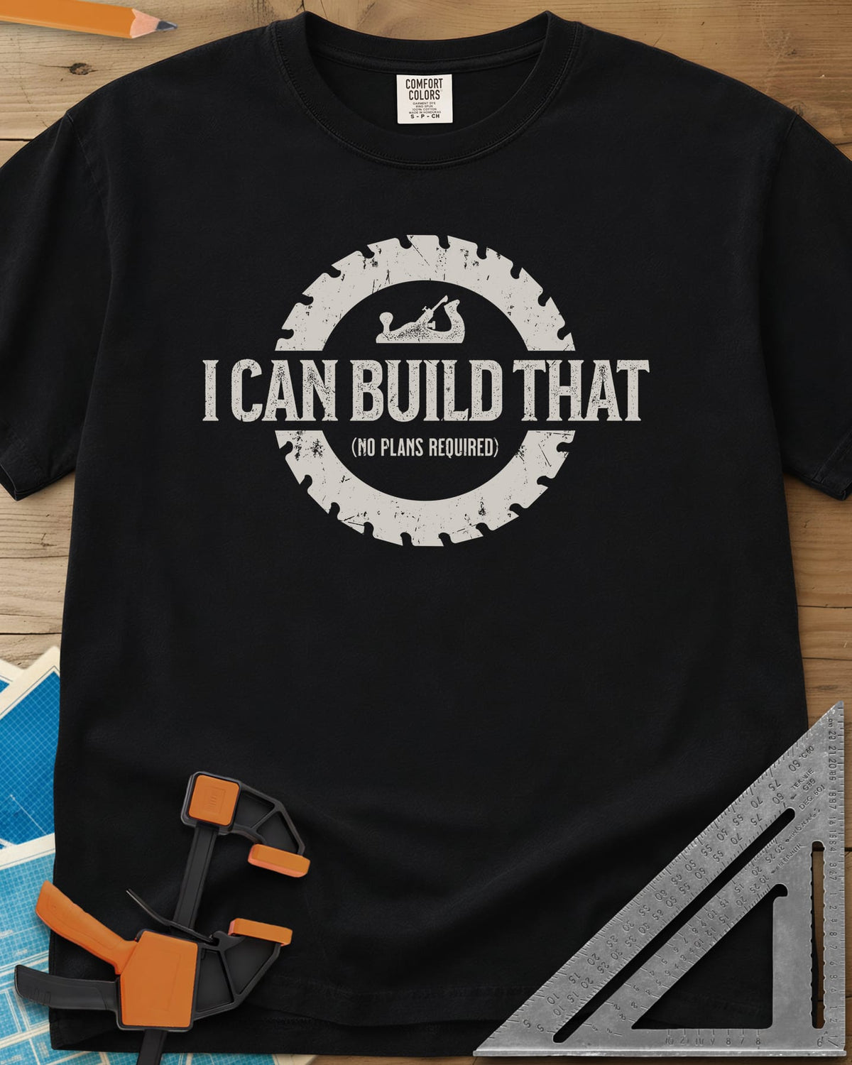 I Can Build That heavyweight tee in Black, distressed lettering in a saw blade ring with a small hand plane
