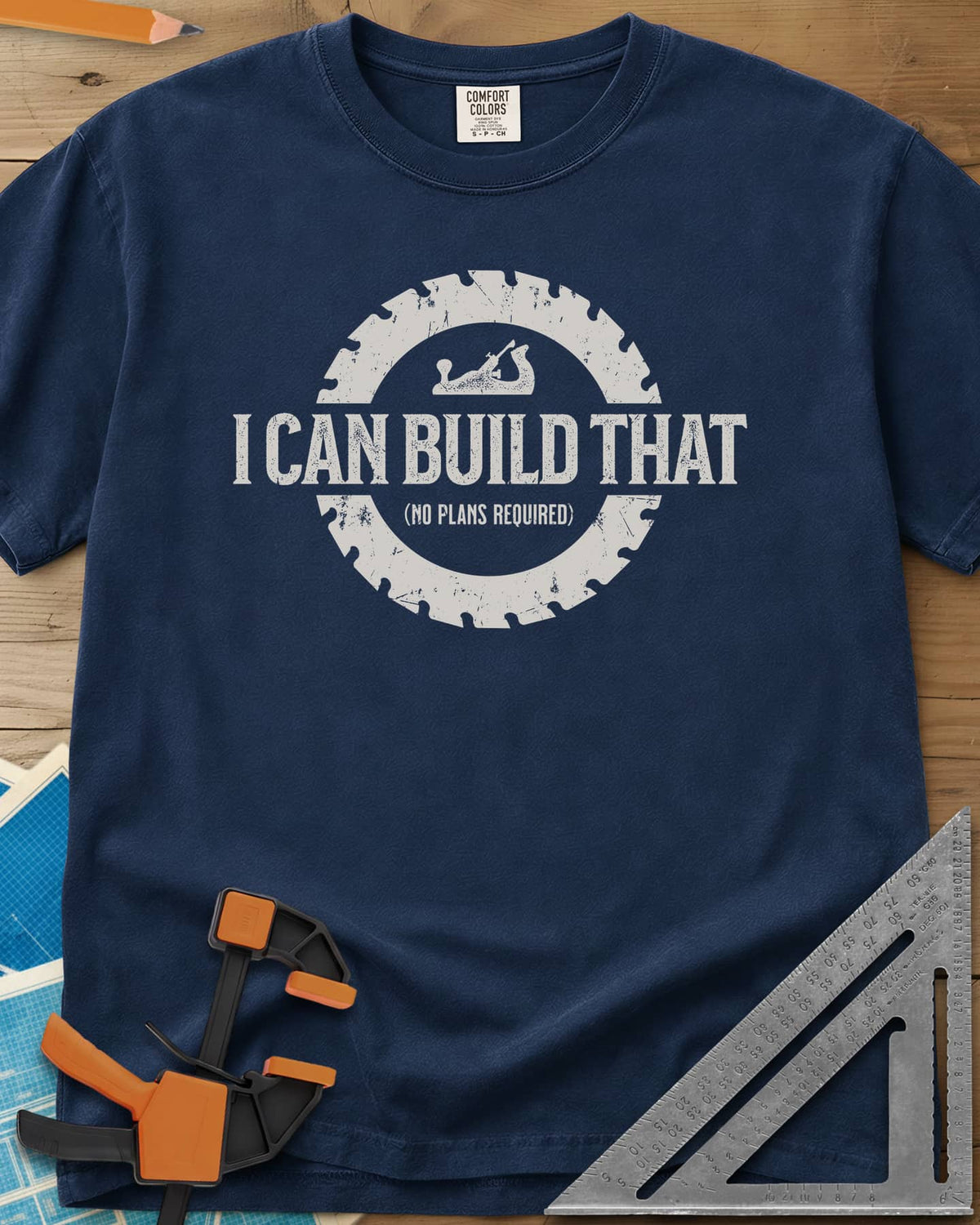 I Can Build That heavyweight tee in Navy, distressed lettering in a saw blade ring with a small hand plane
