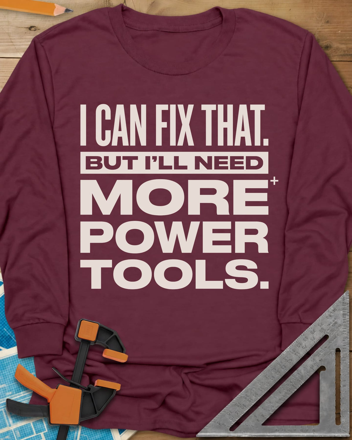 I Can Fix That long sleeve shirt in Maroon, stacked bold lettering with one line reversed out of a bar