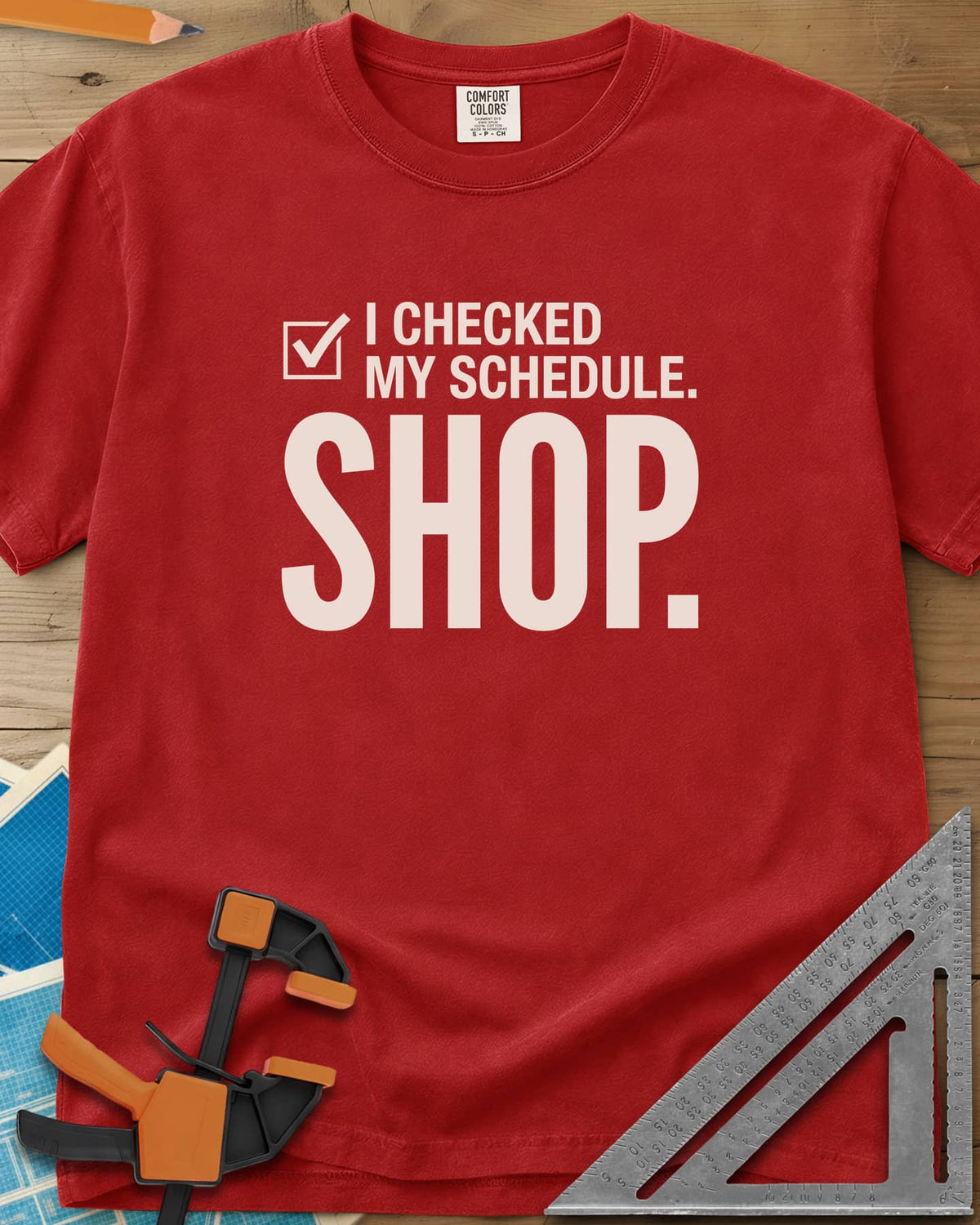 I Checked My Schedule Shop heavyweight tee in Red, a checked box beside small text and a huge SHOP below