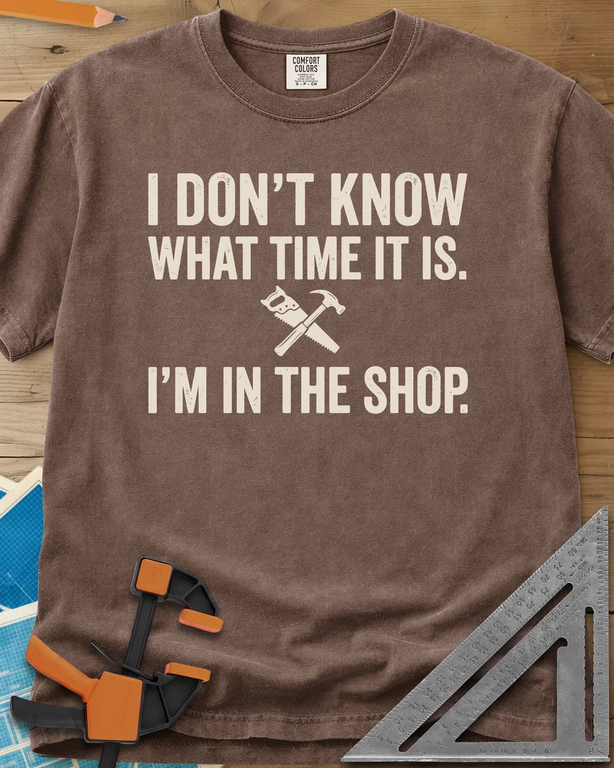 I Don't Know What Time It Is heavyweight tee in Espresso, a small crossed handsaw and hammer between two lines of text