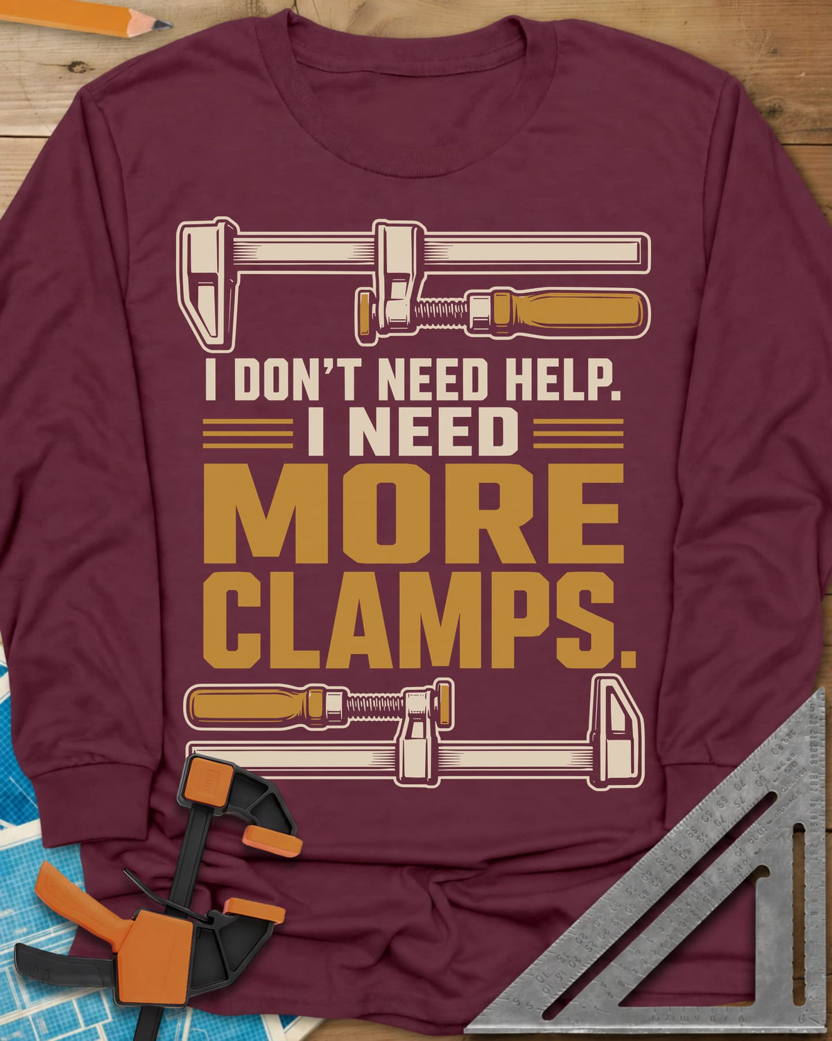 I Don't Need Help I Need More Clamps long sleeve shirt in Maroon, two bar clamps above and below bold stacked lettering