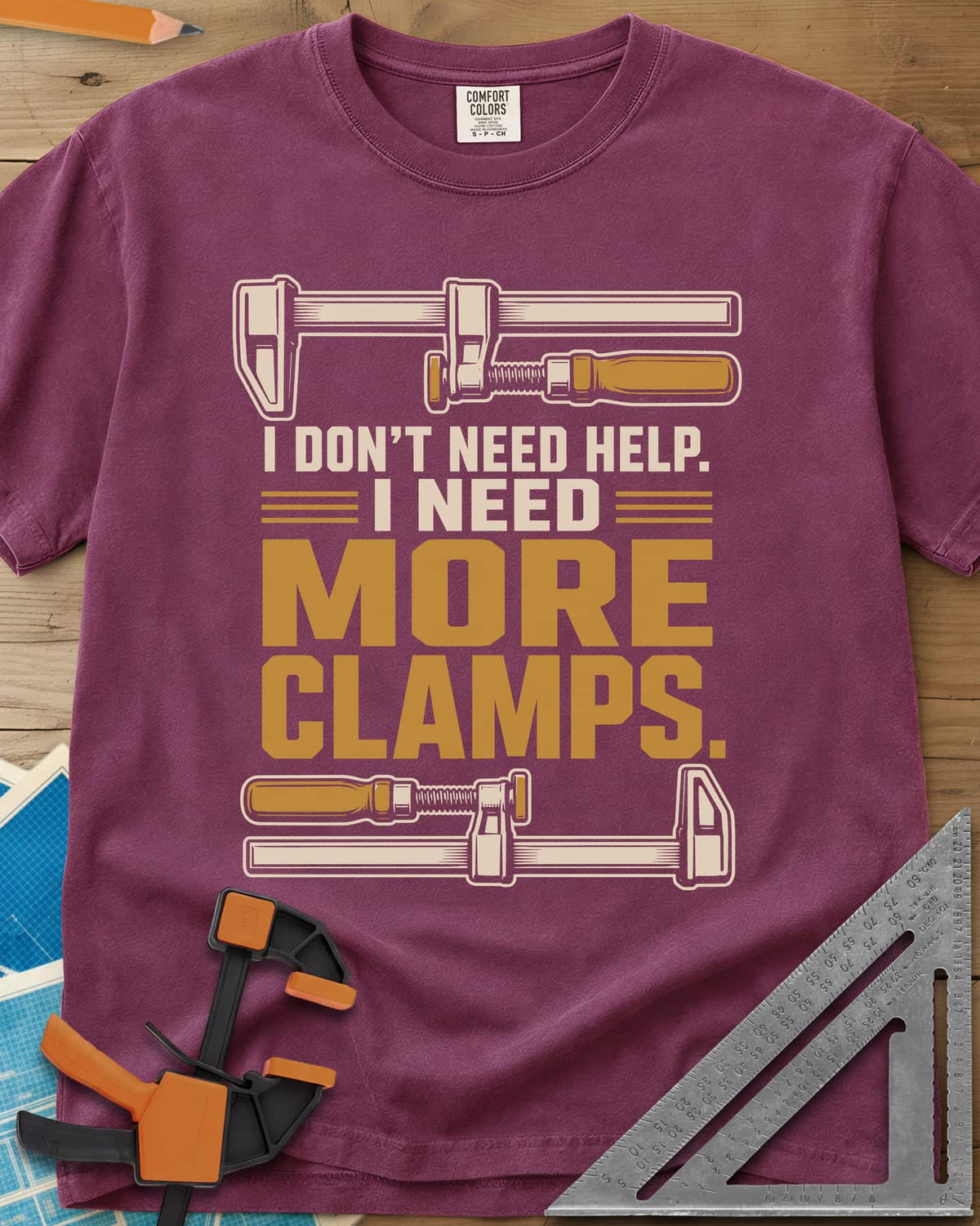 I Don't Need Help I Need More Clamps heavyweight tee in Berry, two bar clamps above and below bold stacked lettering